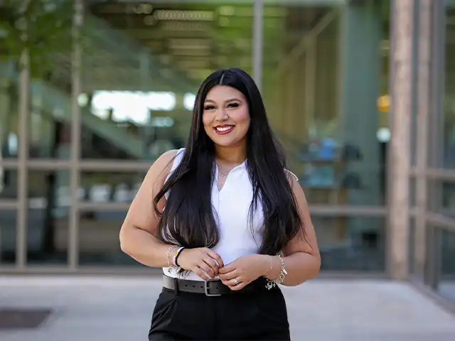 female grad student headshot outside the library