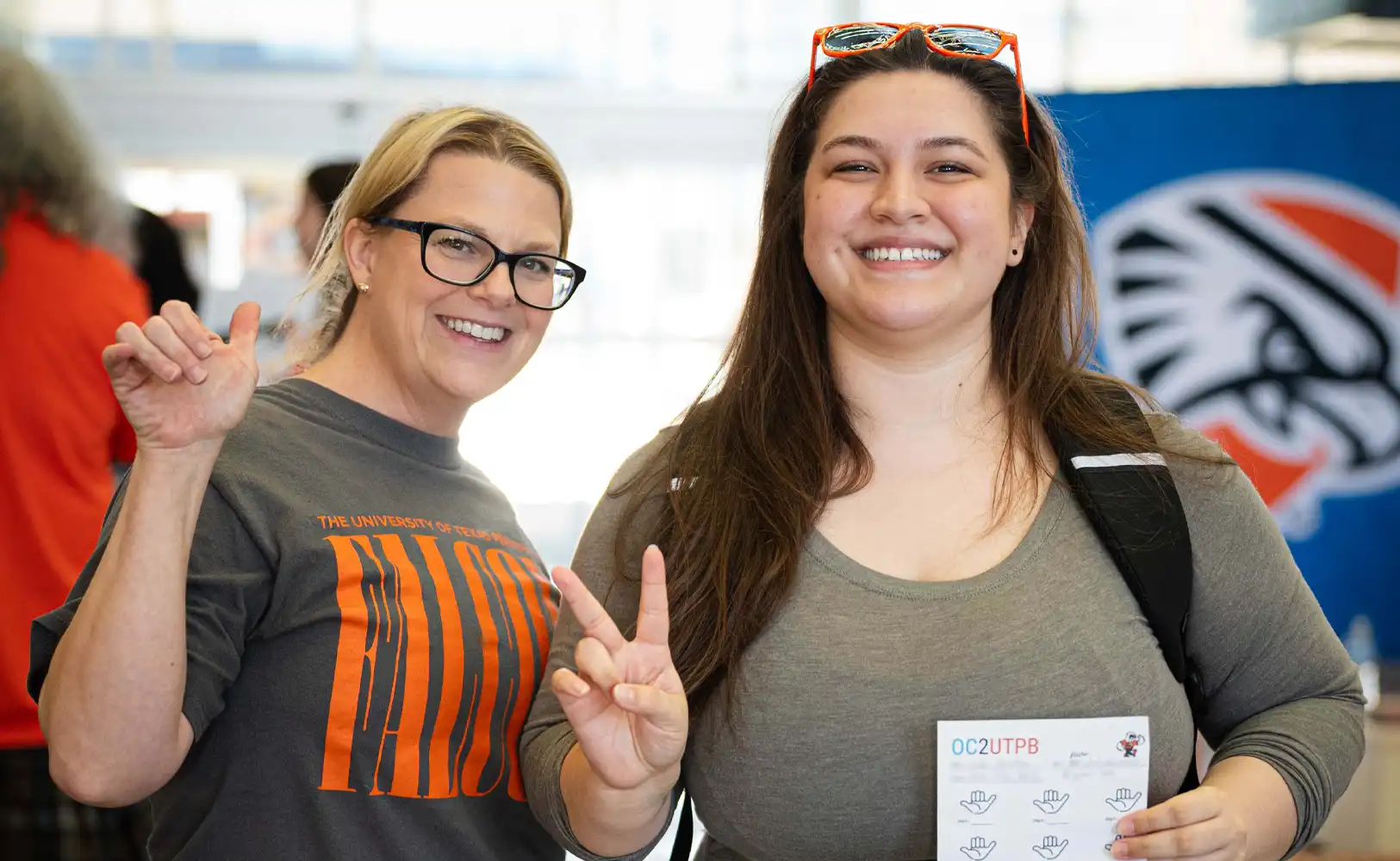A UTPB staff member pictured with an Odessa College student at a transfer fair. 