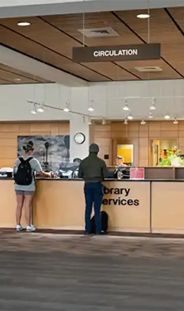 students standing at the Library Services Counter