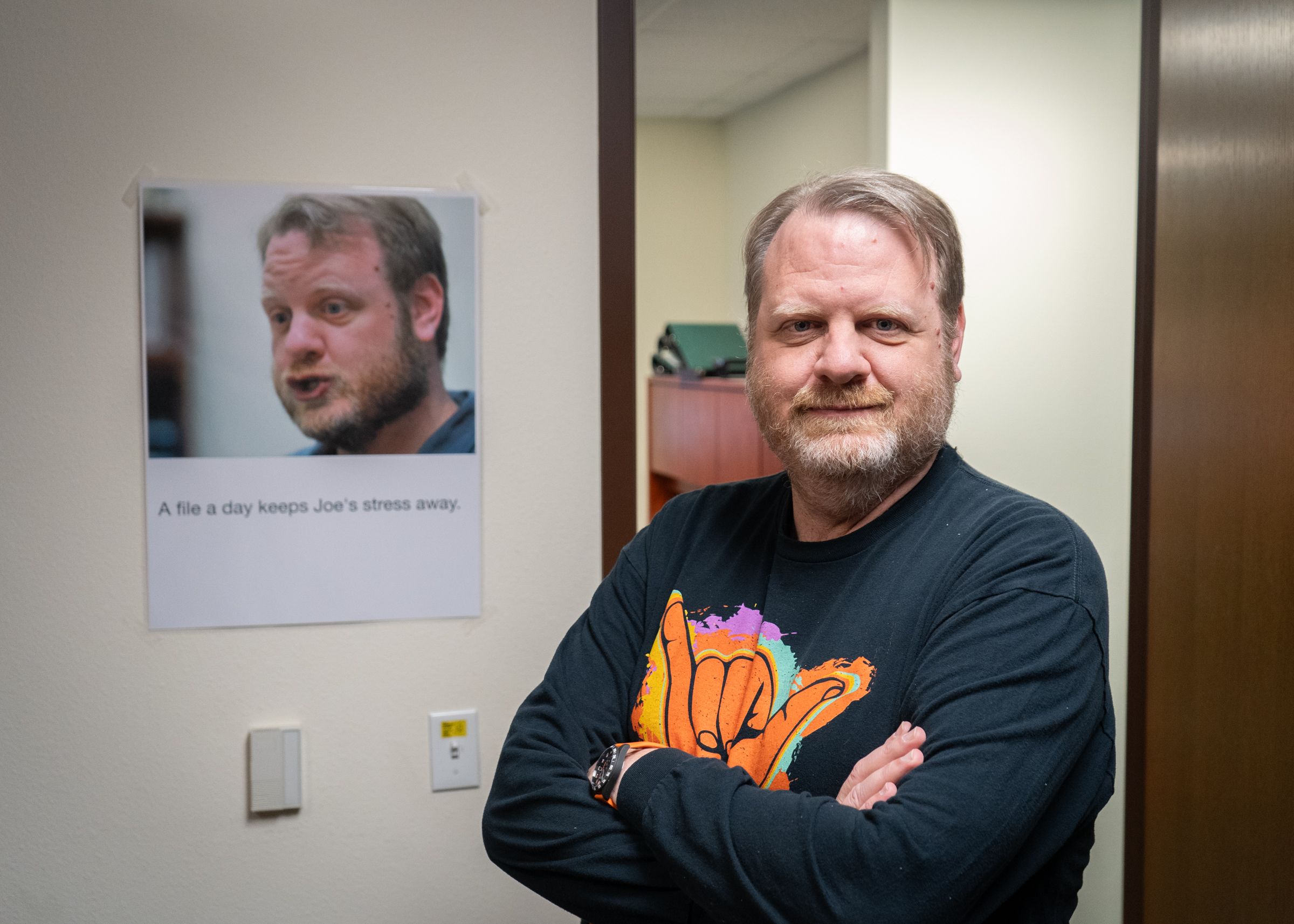 Joe Sanders standing with his arms crossed 