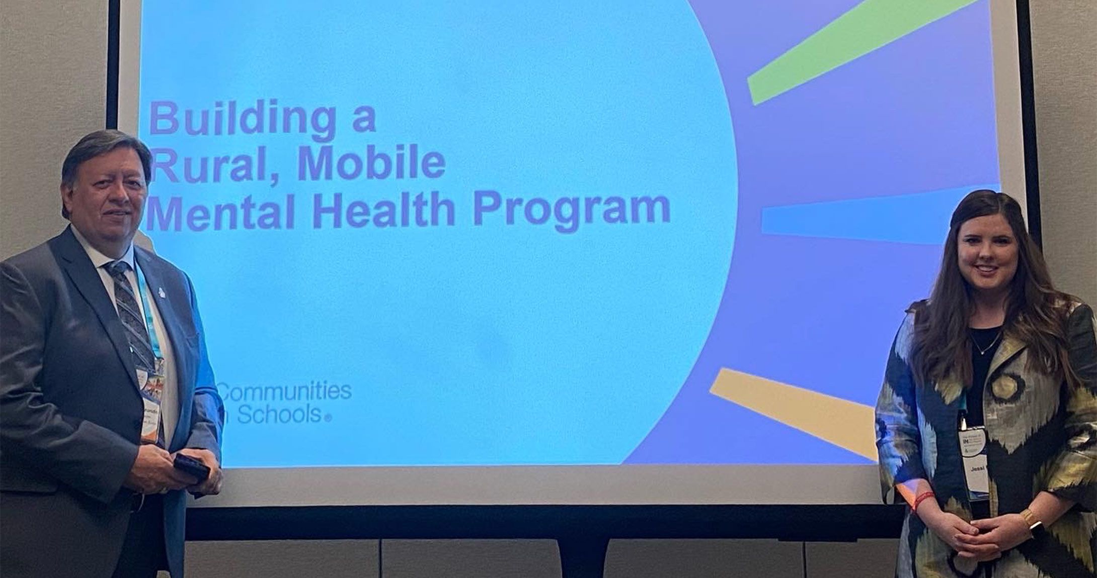 Jessi Morgan smiling in front of presentation 