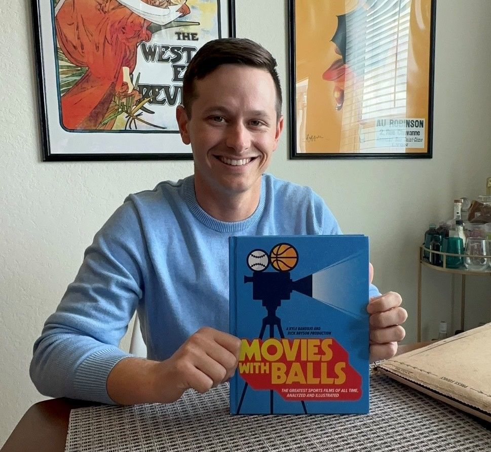Kyle Bandujo showing off book cover