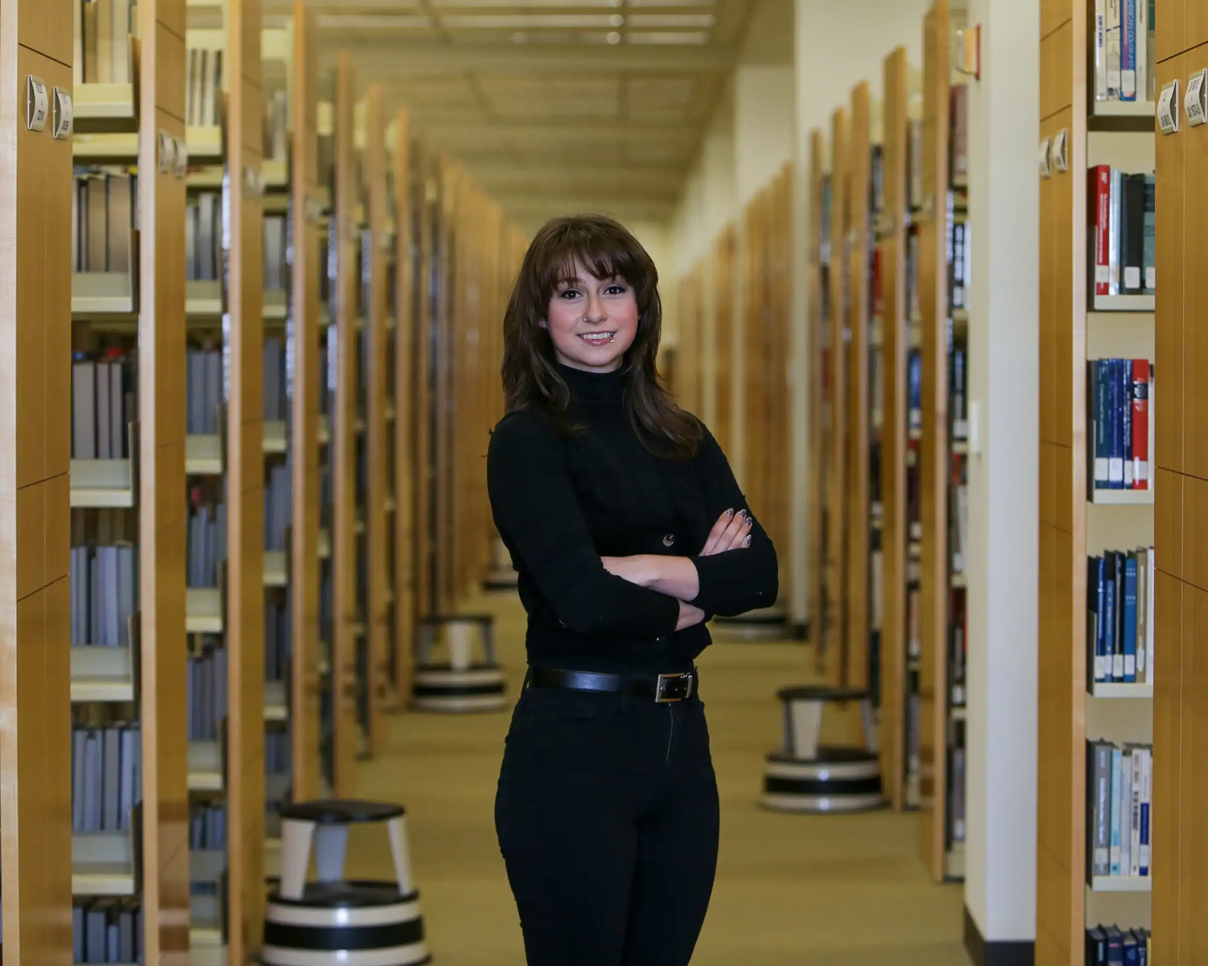 Alexa Nease standing in a library. 