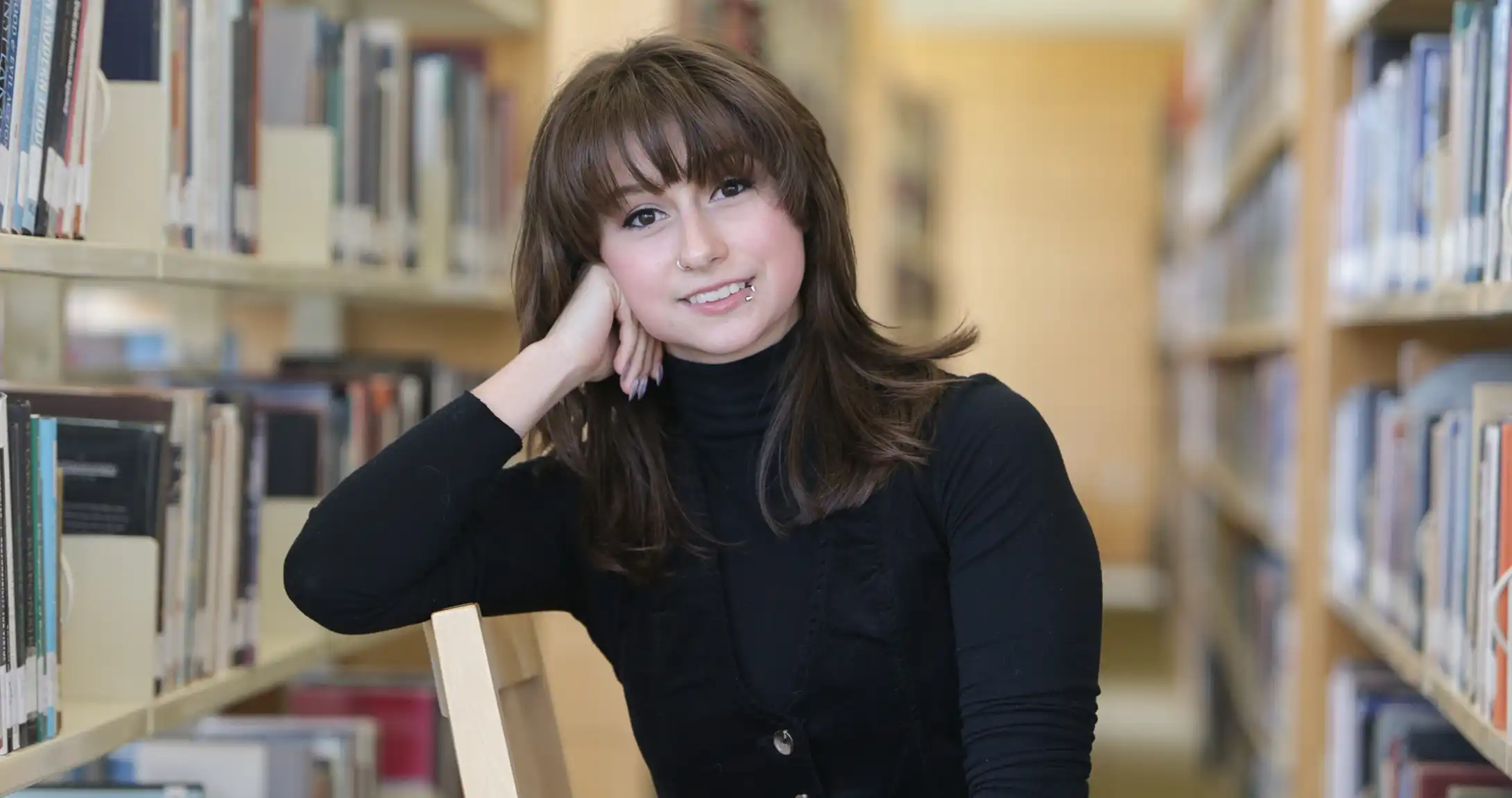 Alexa Nease sitting in a library. 