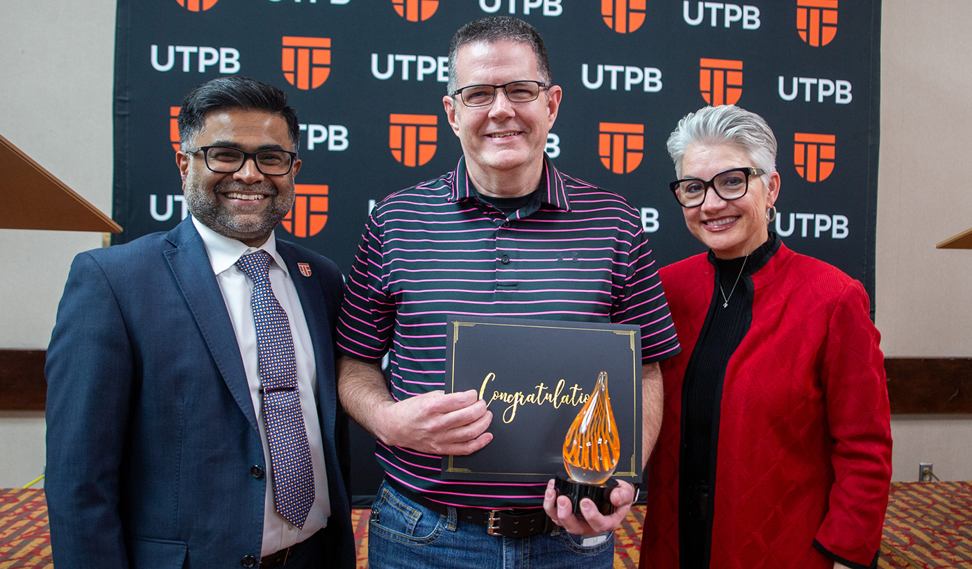 UTPB faculty award winner with President and Provost