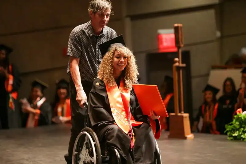 Barlett Caballero crossing the stage at UTPB graduation. 