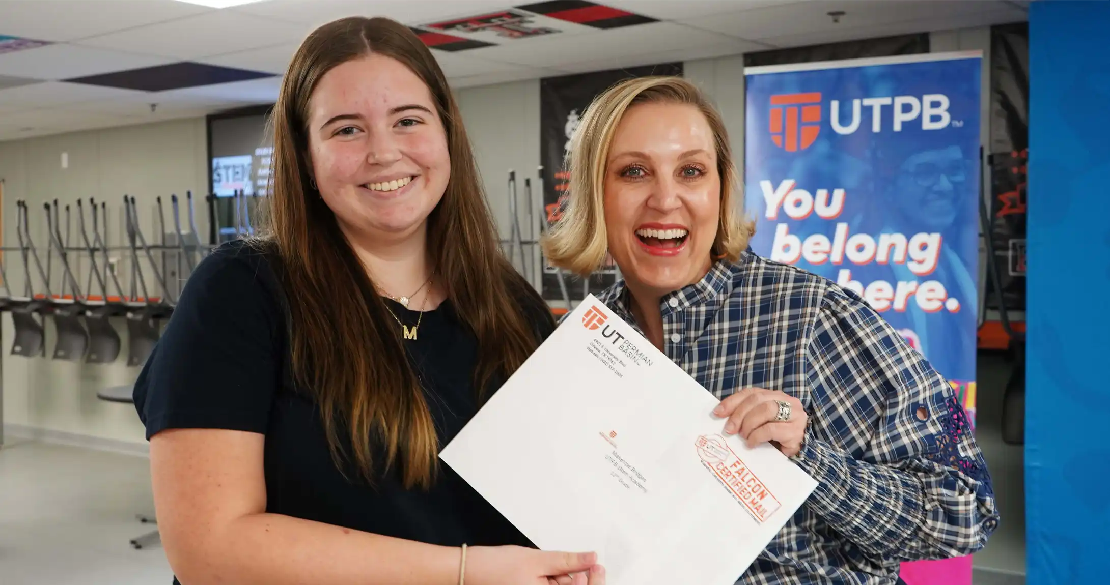 UTPB's Senior Vice President for Student Affairs and Enrollment Management, Dr. Becky Spurlock, presenting a senior with their Direct Admissions packet. 