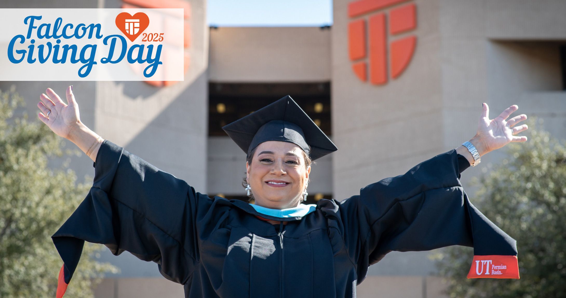 Falcon Giving Day 2025, Graduate with open arms in front of UTPB Mesa Building