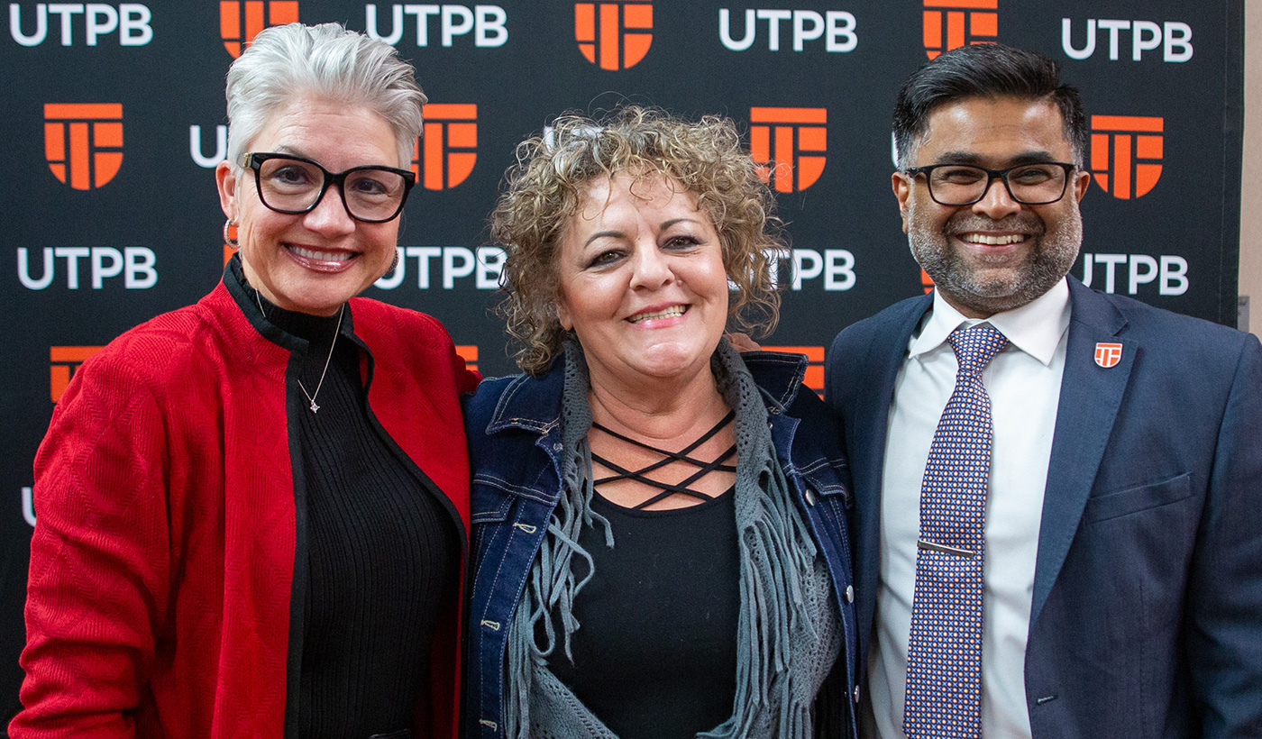 Impact Award winner with president and provost
