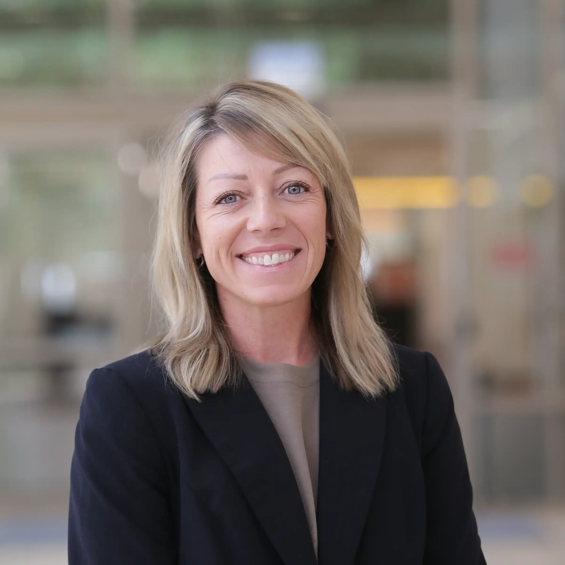 Lora Bedard smiling in a hall at UTPB. 