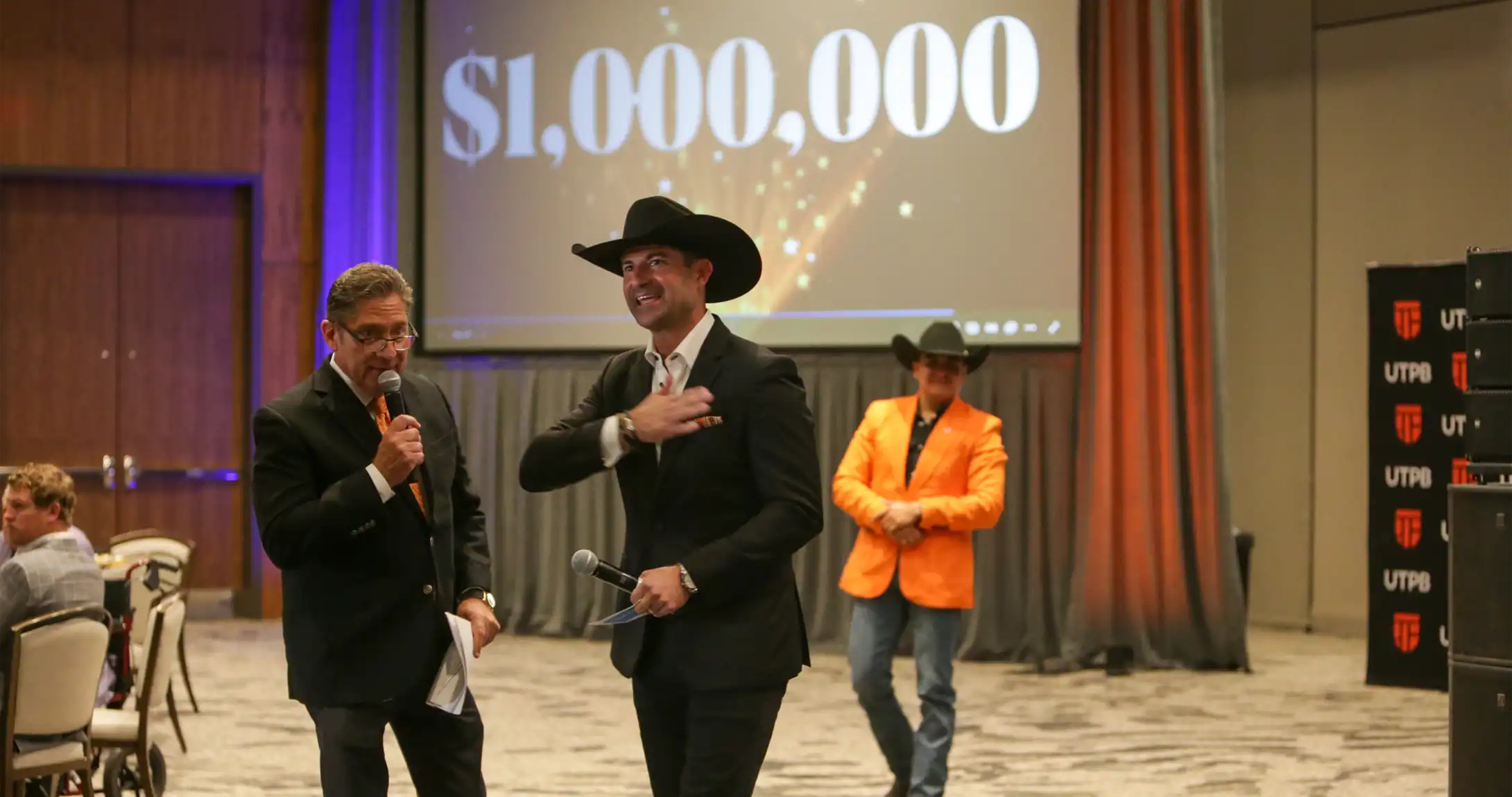 Attendees celebrating as UTPB reaches $1 million raised for UTPB scholarships.