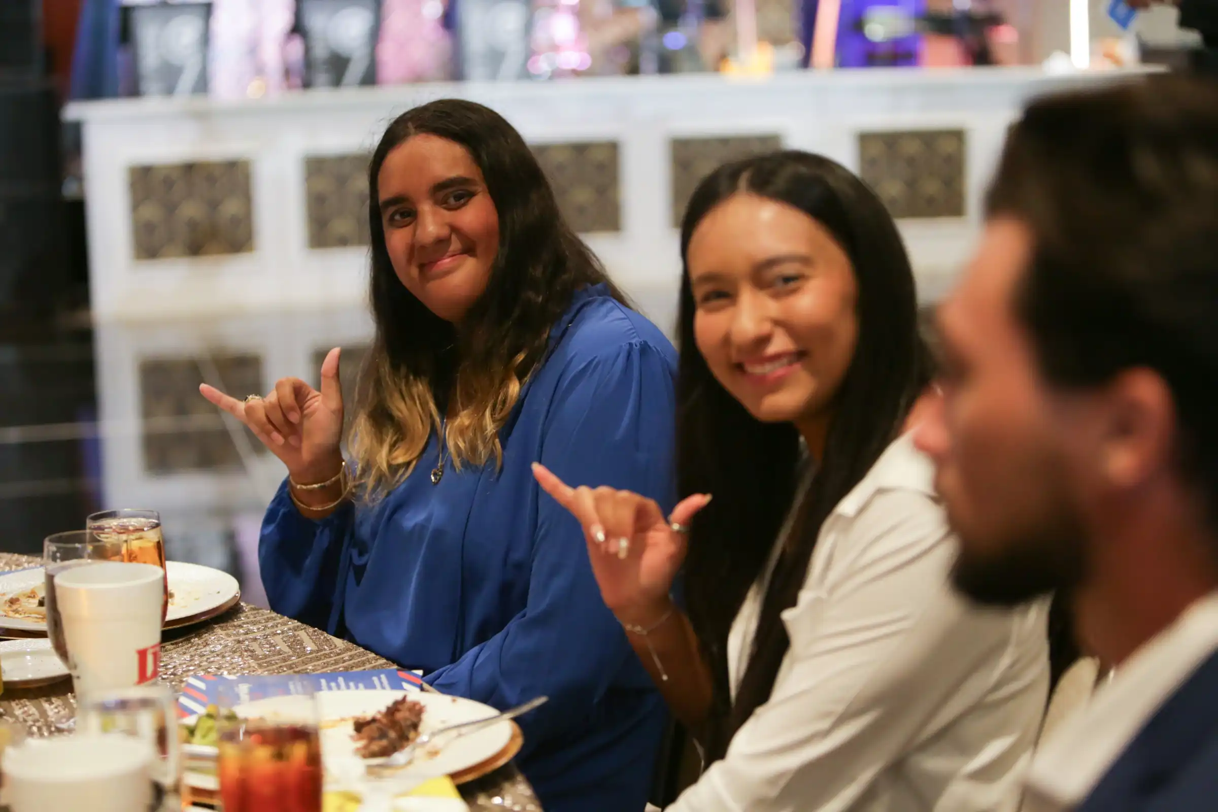 UTPB students holding "Falcons Up" at Scholarship Ball.