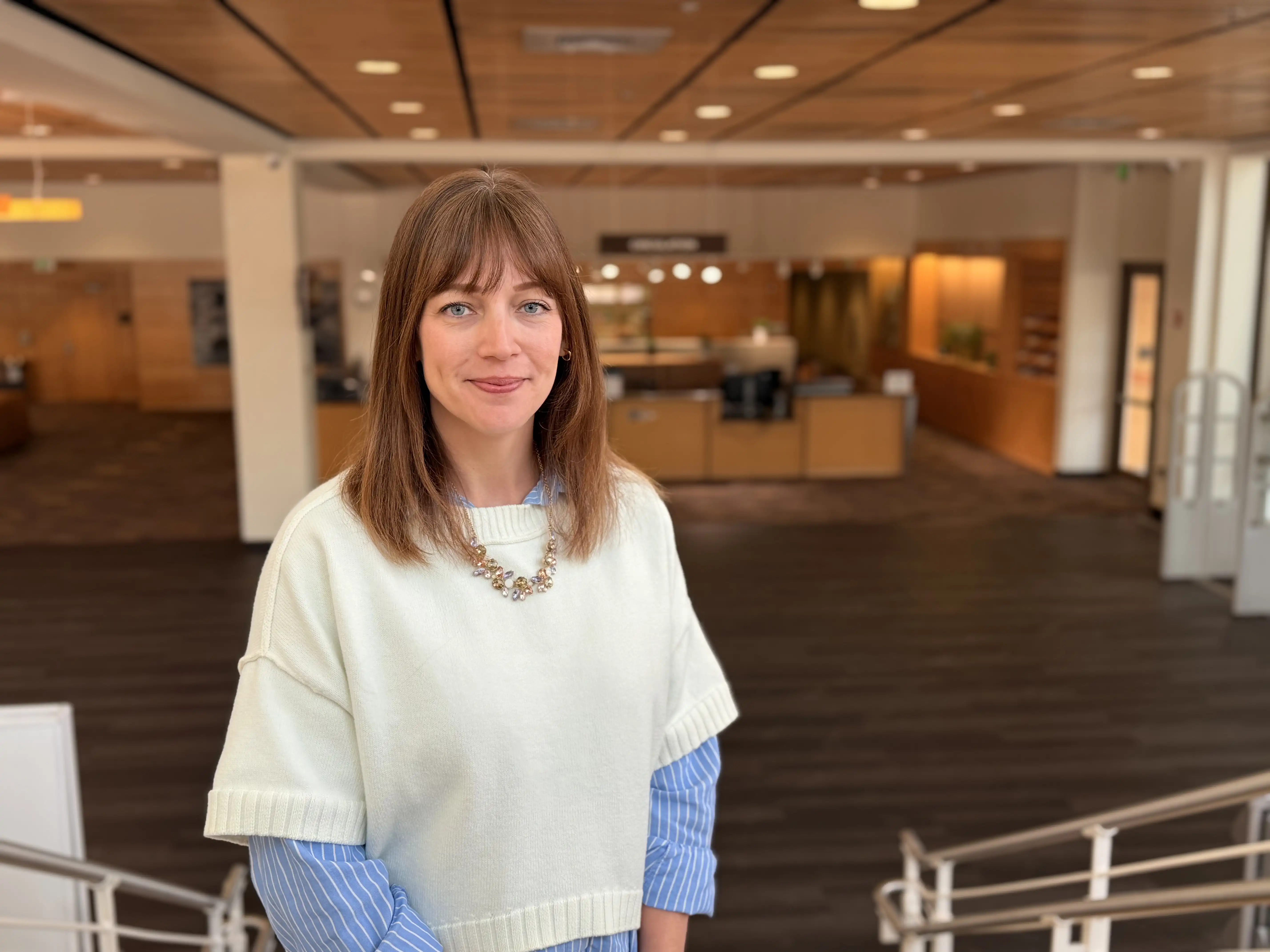 Adrian Lodge standing on stairs in the UTPB library. 