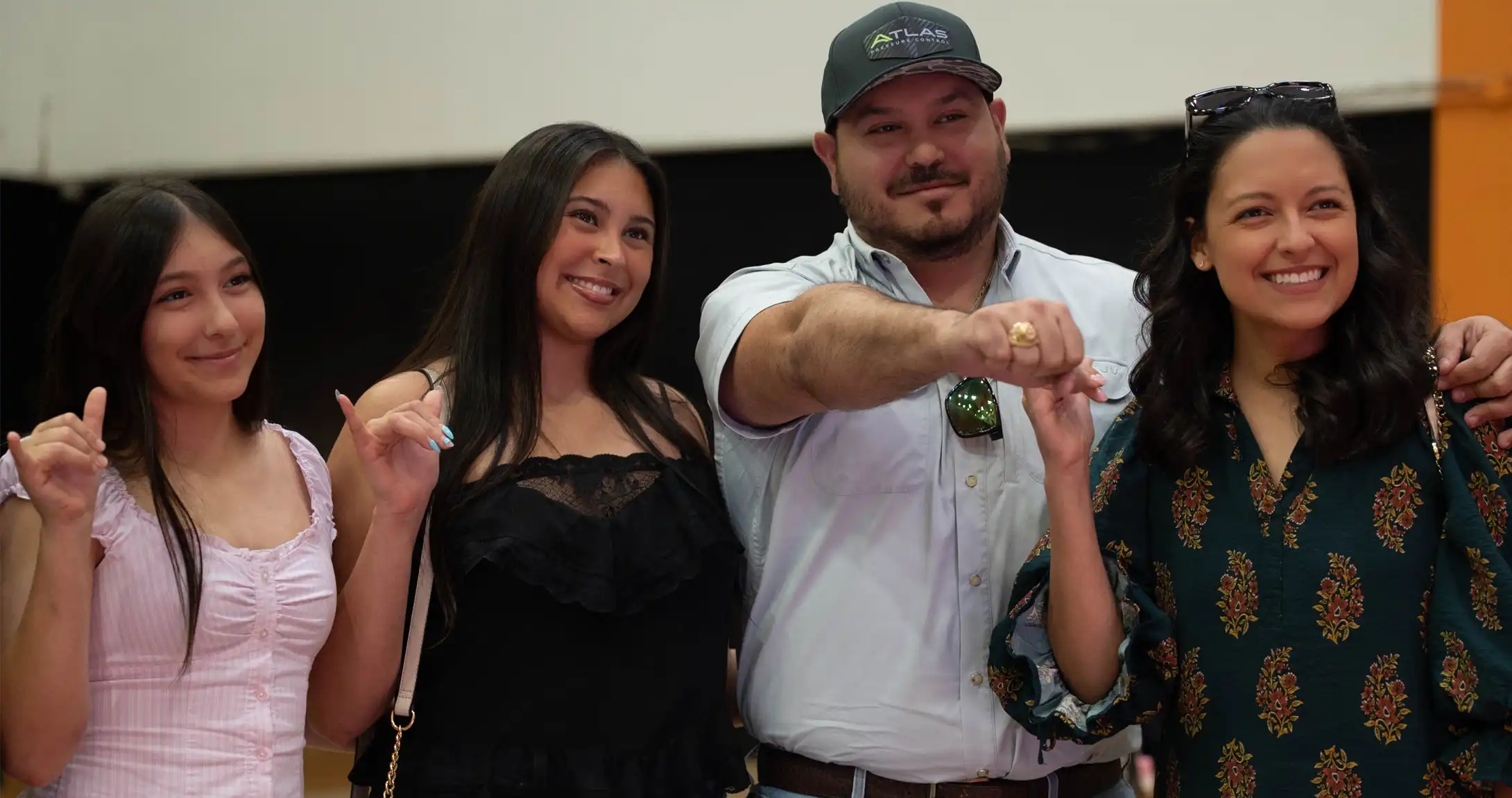 UTPB graduate John Cortinas poses for a photo with his wife and two daughters after receiving his class ring.