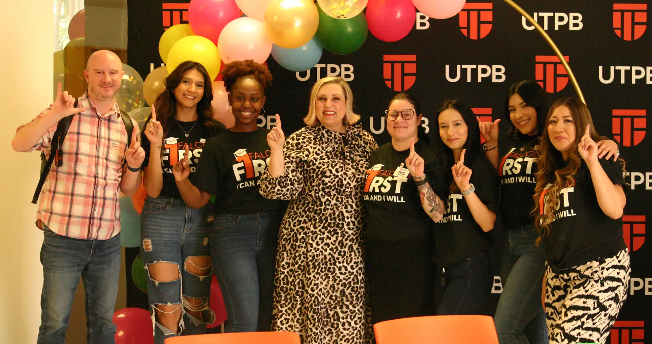First-generation students at UTPB pictured holding their number one up with Corey Benson and Dr. Becky Spurlock. 