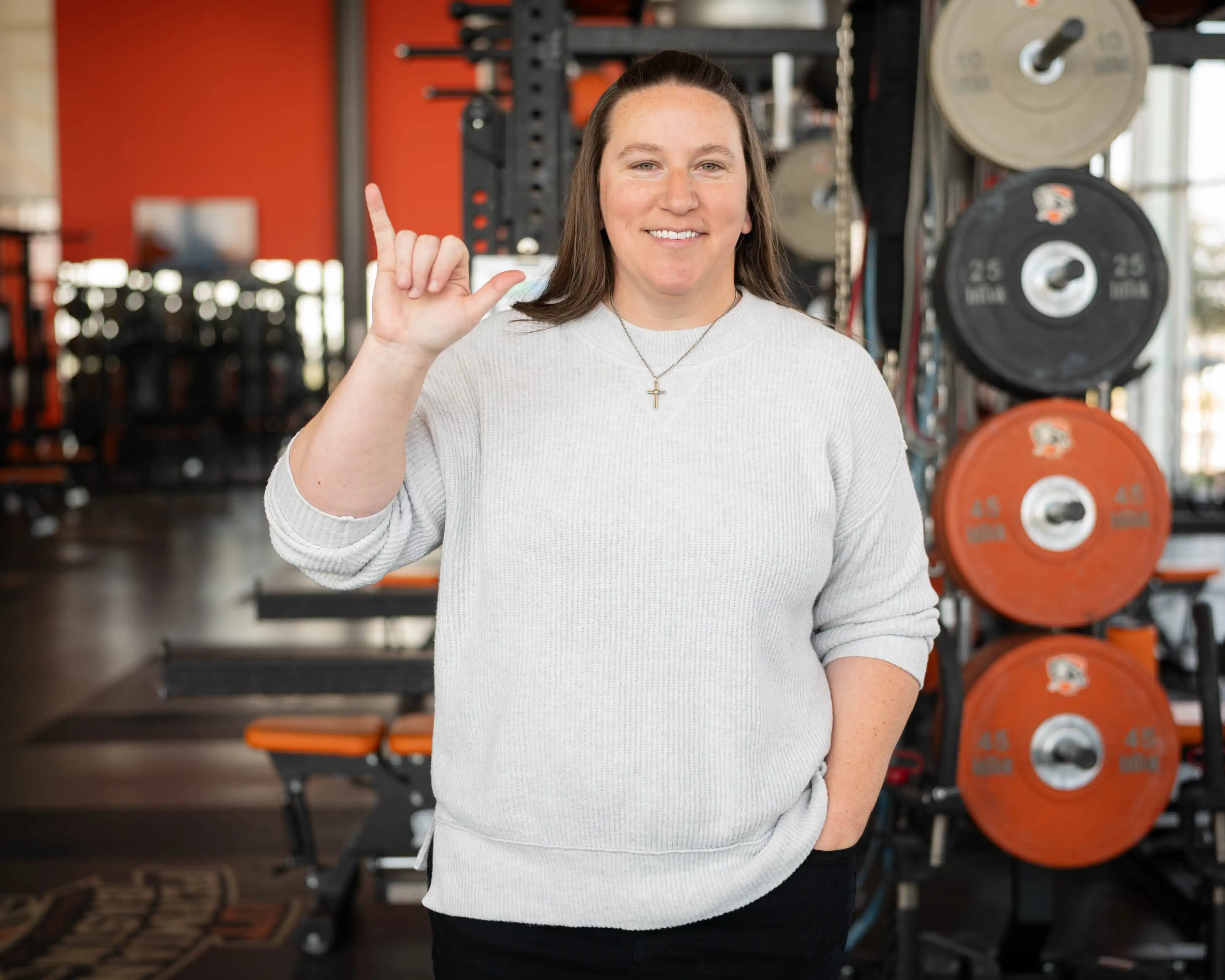 UTPB's Ginger Gatliff pictured in the weight room holding Falcons Up.