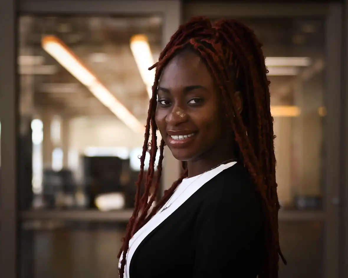 Halimat Popoola taking her headshot in the on-campus library. 