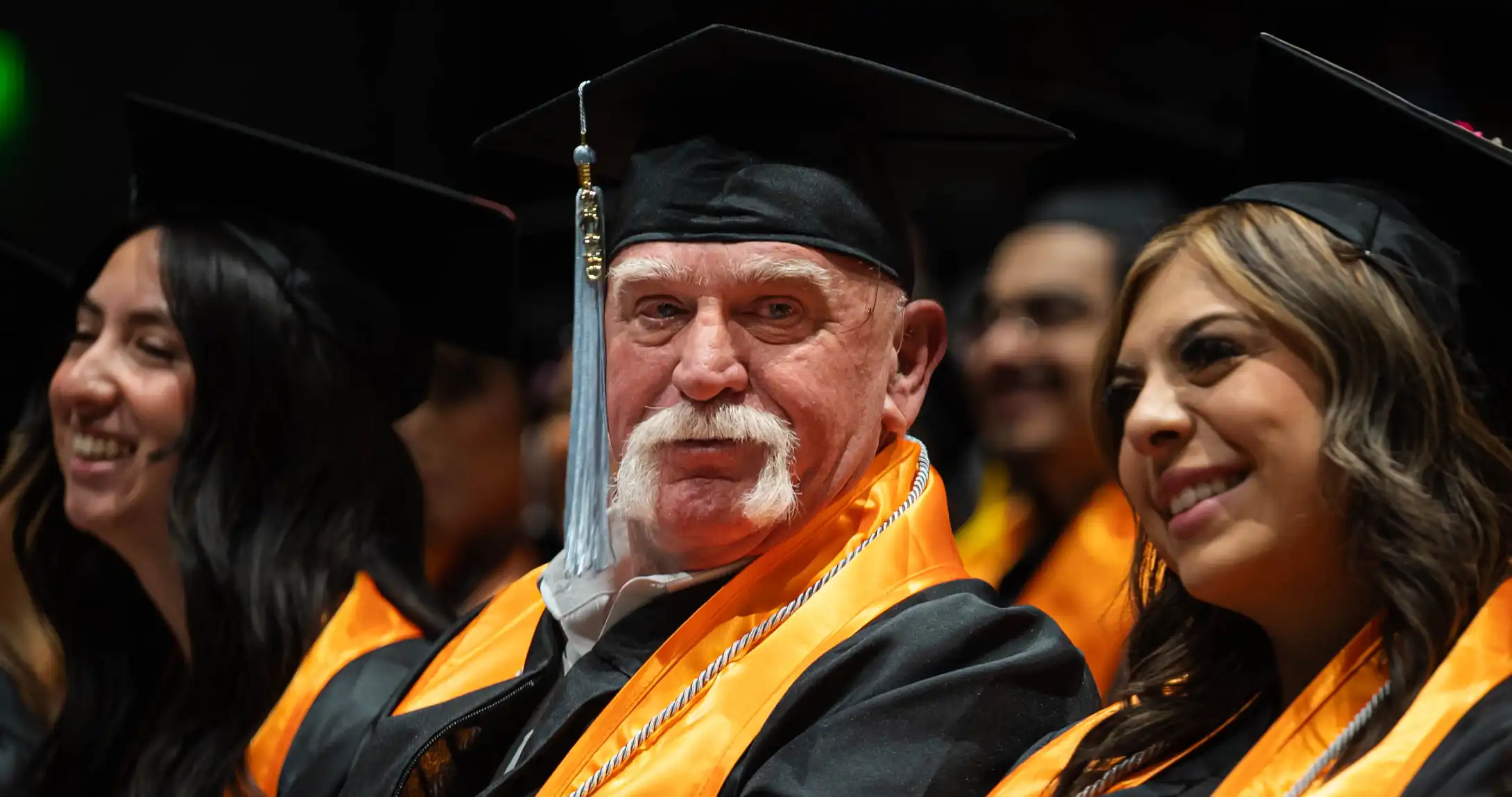 Larry Wallum sitting at UTPB's commencement in his regalia. 