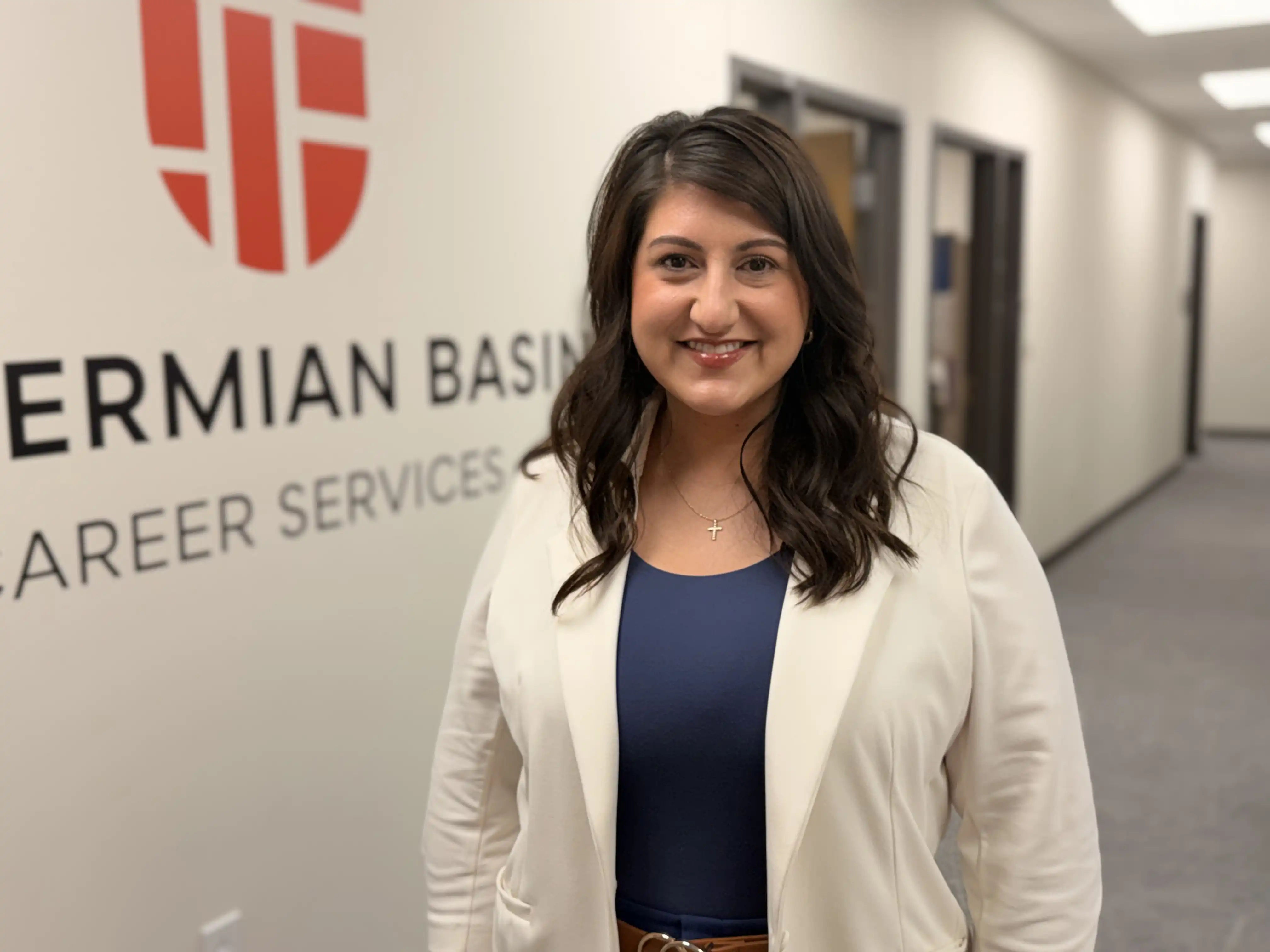 UTPB's Megan Baeza standing in front of a Career Services logo.