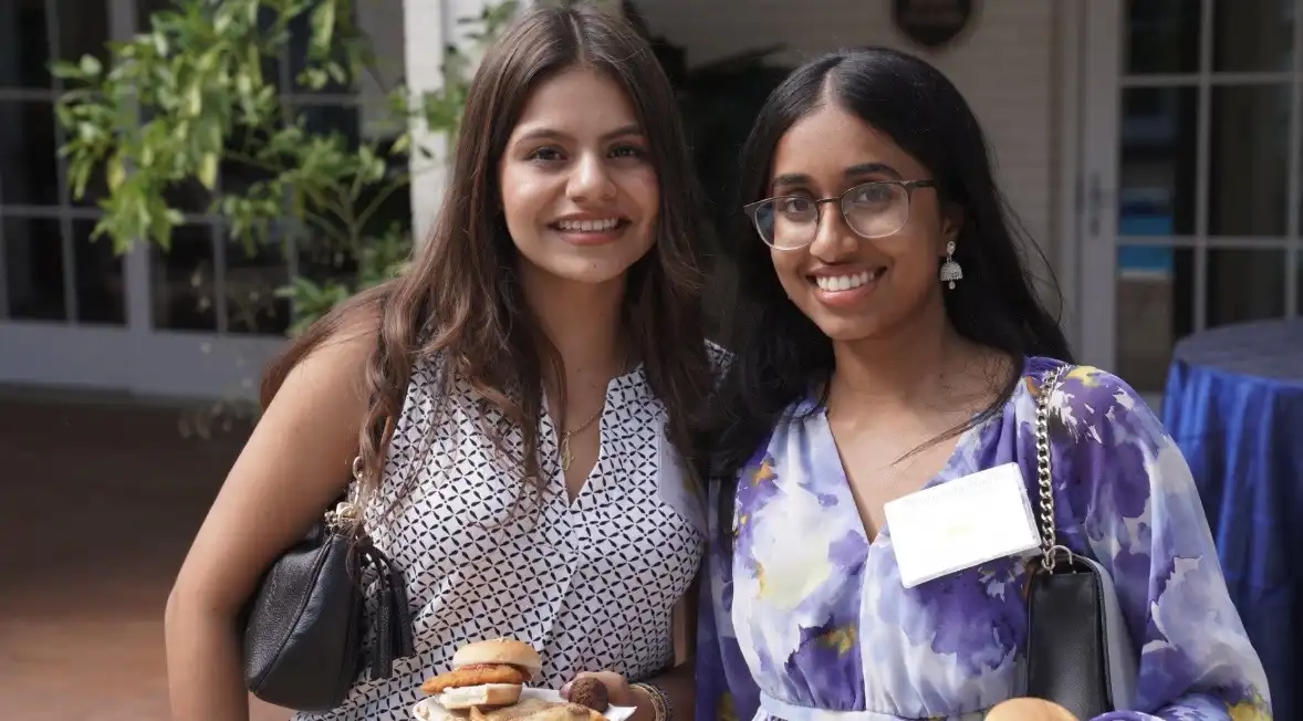 Angelina Hernandez posing for a photo with another university lands intern.