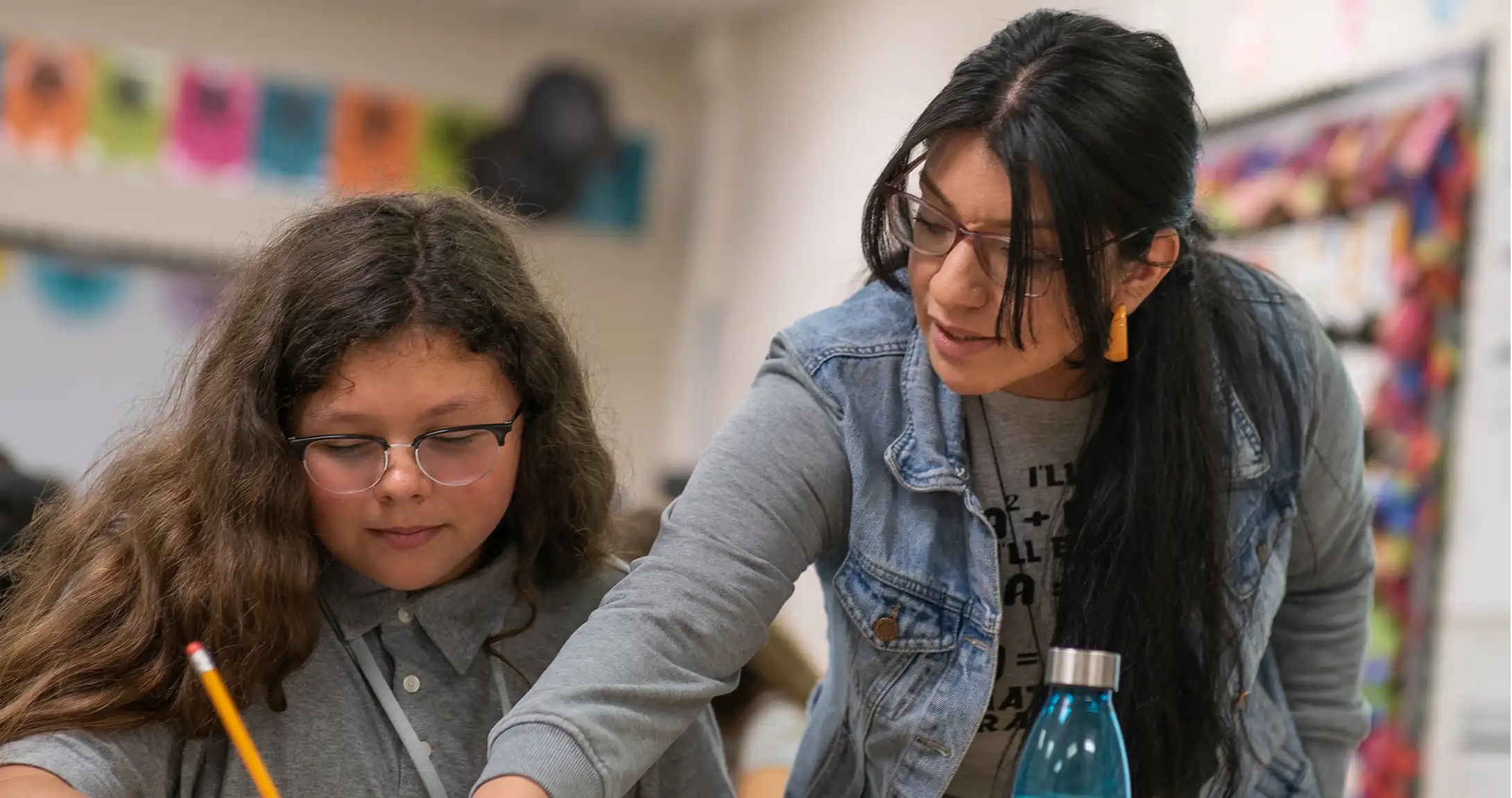 A teacher helping a student with their work,