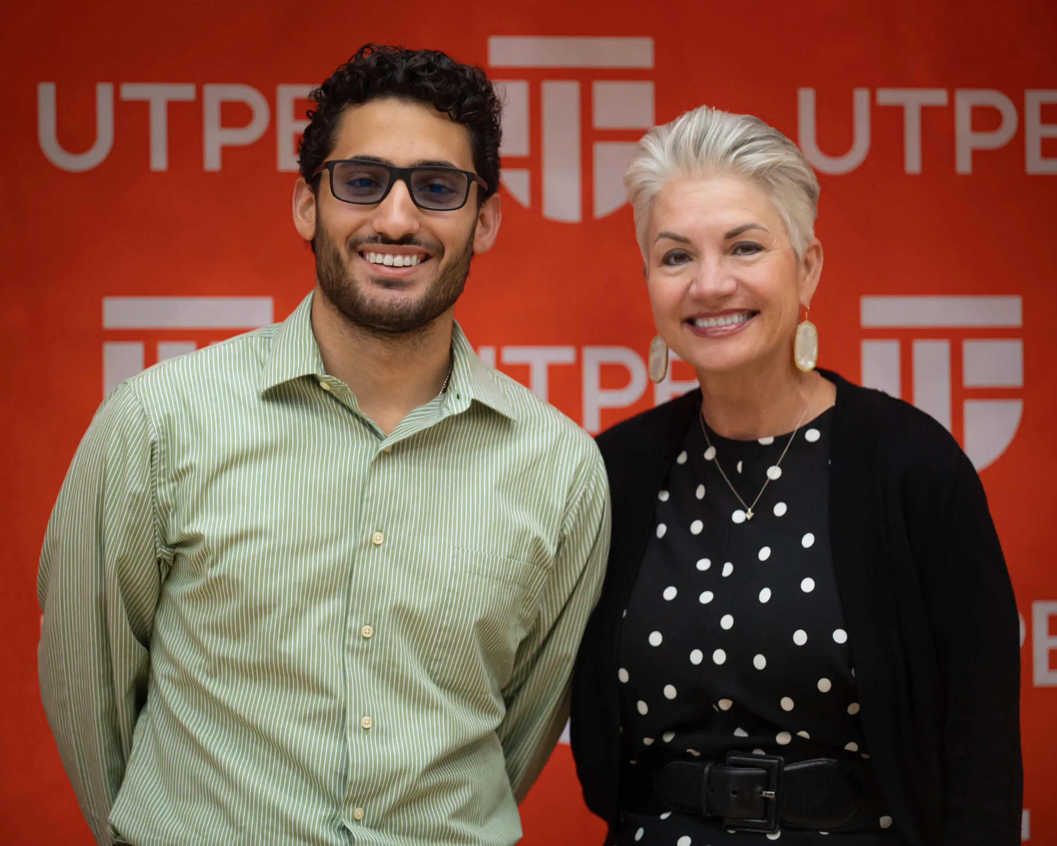 UTPB recent grad Andres Barbar Molero posing for a photo with President Woodley after receiving his class ring. 