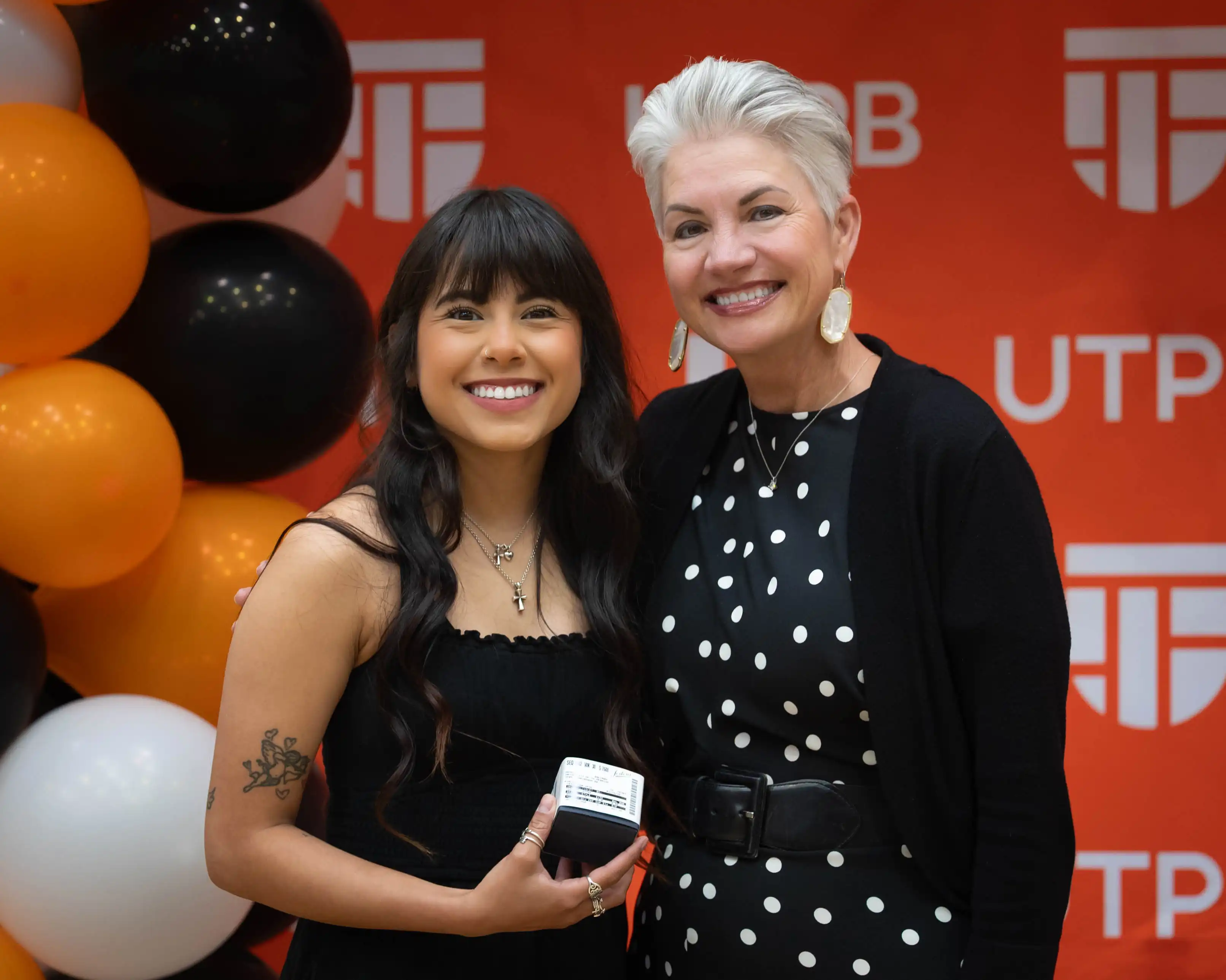 UTPB grad student Nayeli Galindo posing for a photo with president Woodley after receiving her class ring.