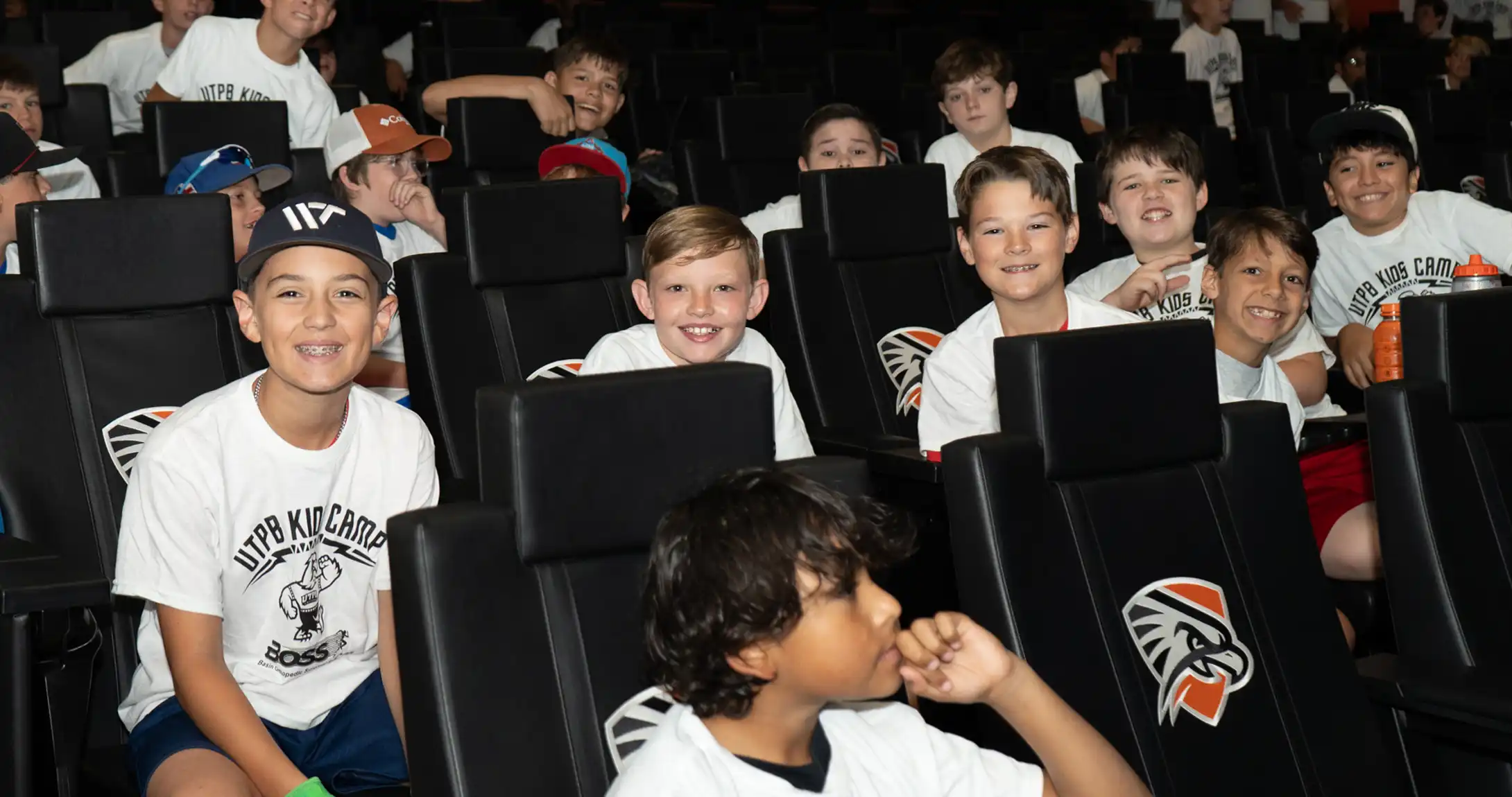 Kids participating in the Summer 2024 Football Camp with smiles on their face. 