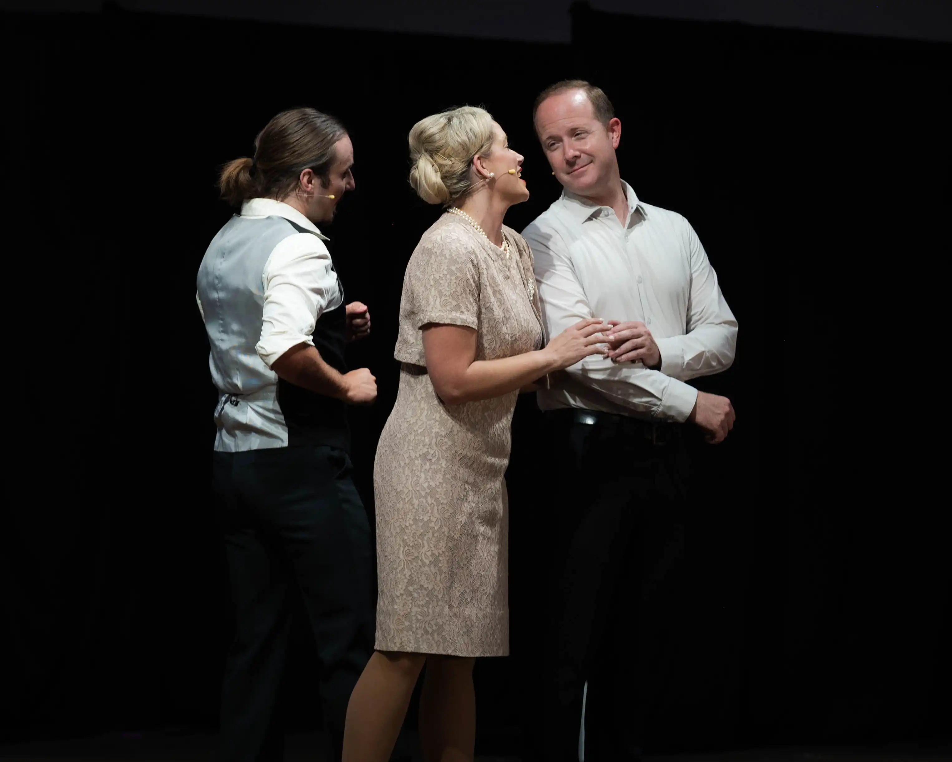Eric Baker standing on stage with another performer.