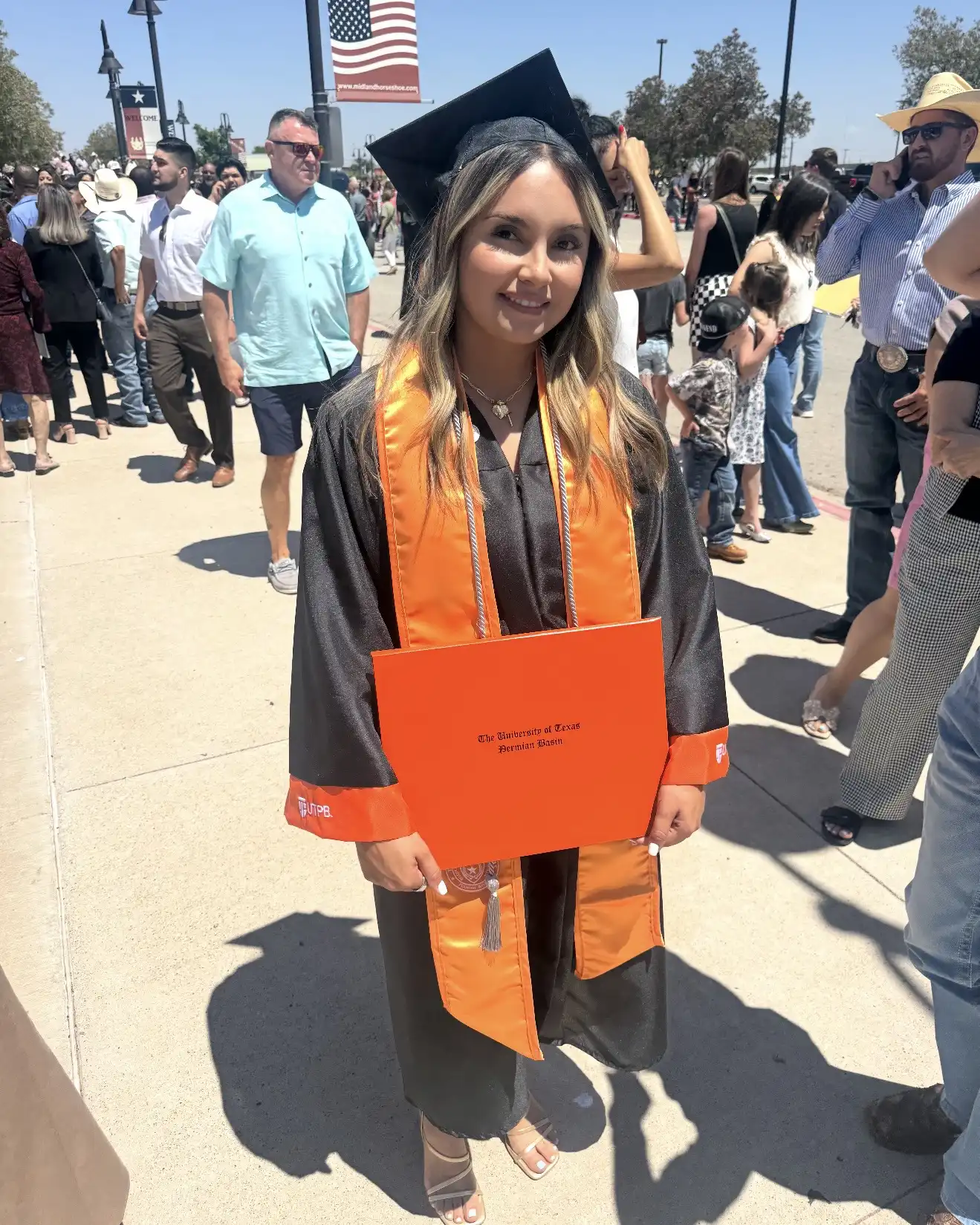 Vivian Galindo holding her diploma after UTPB's graduation ceremony. 