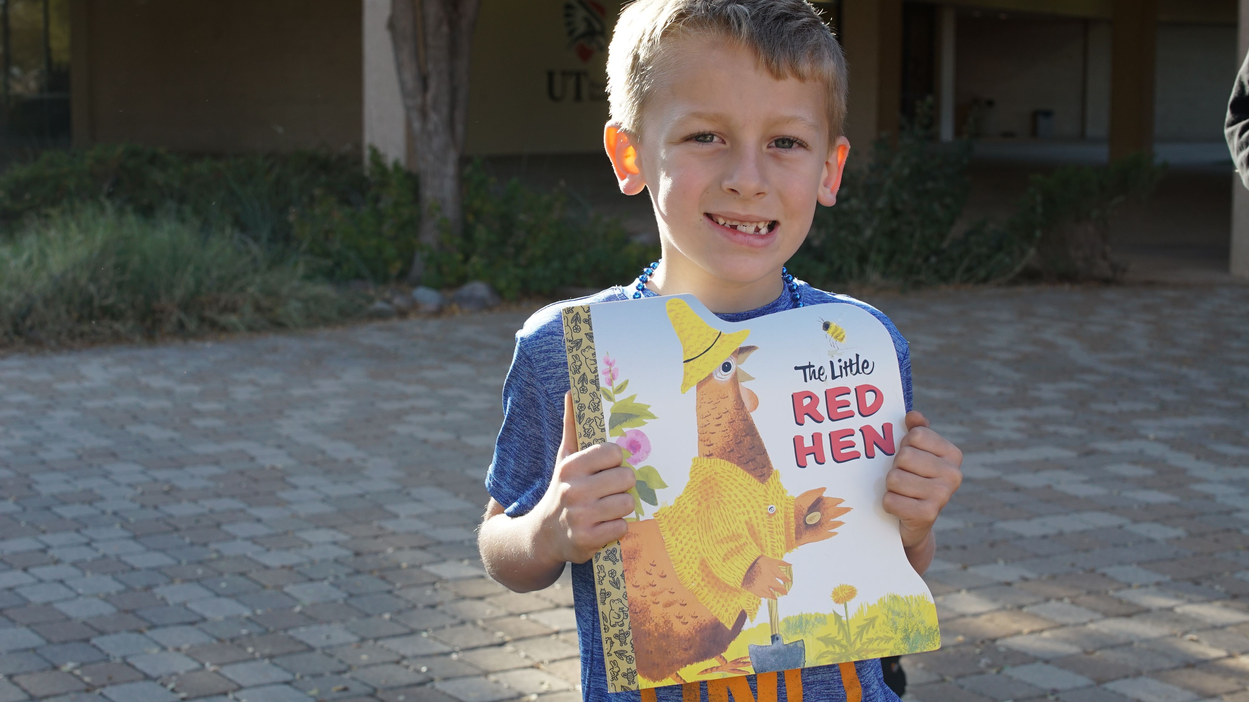 Colton Gregg holding donated book