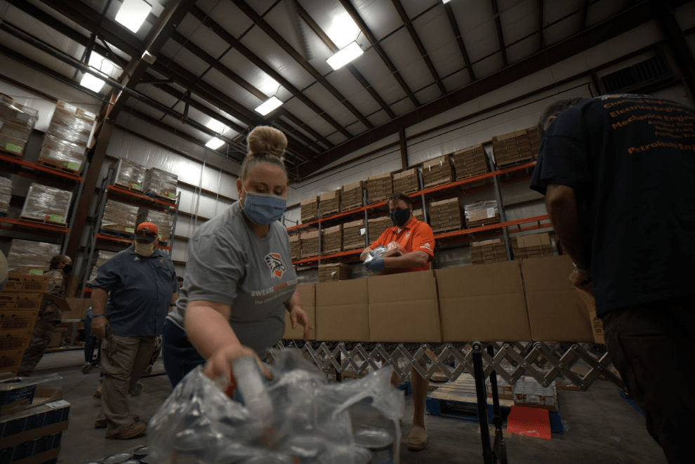 Faculty sacking food at food bank