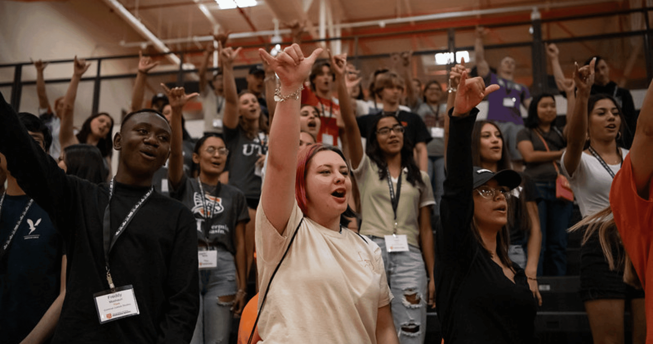 students with hands in air