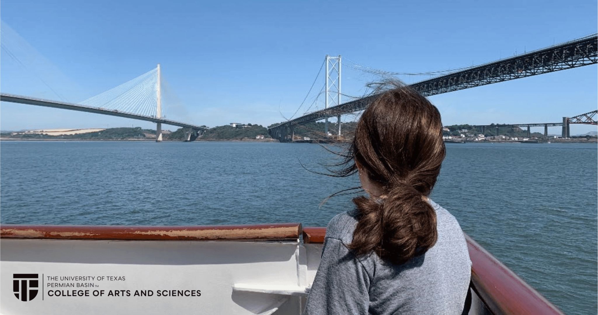 student on boat going under bridge