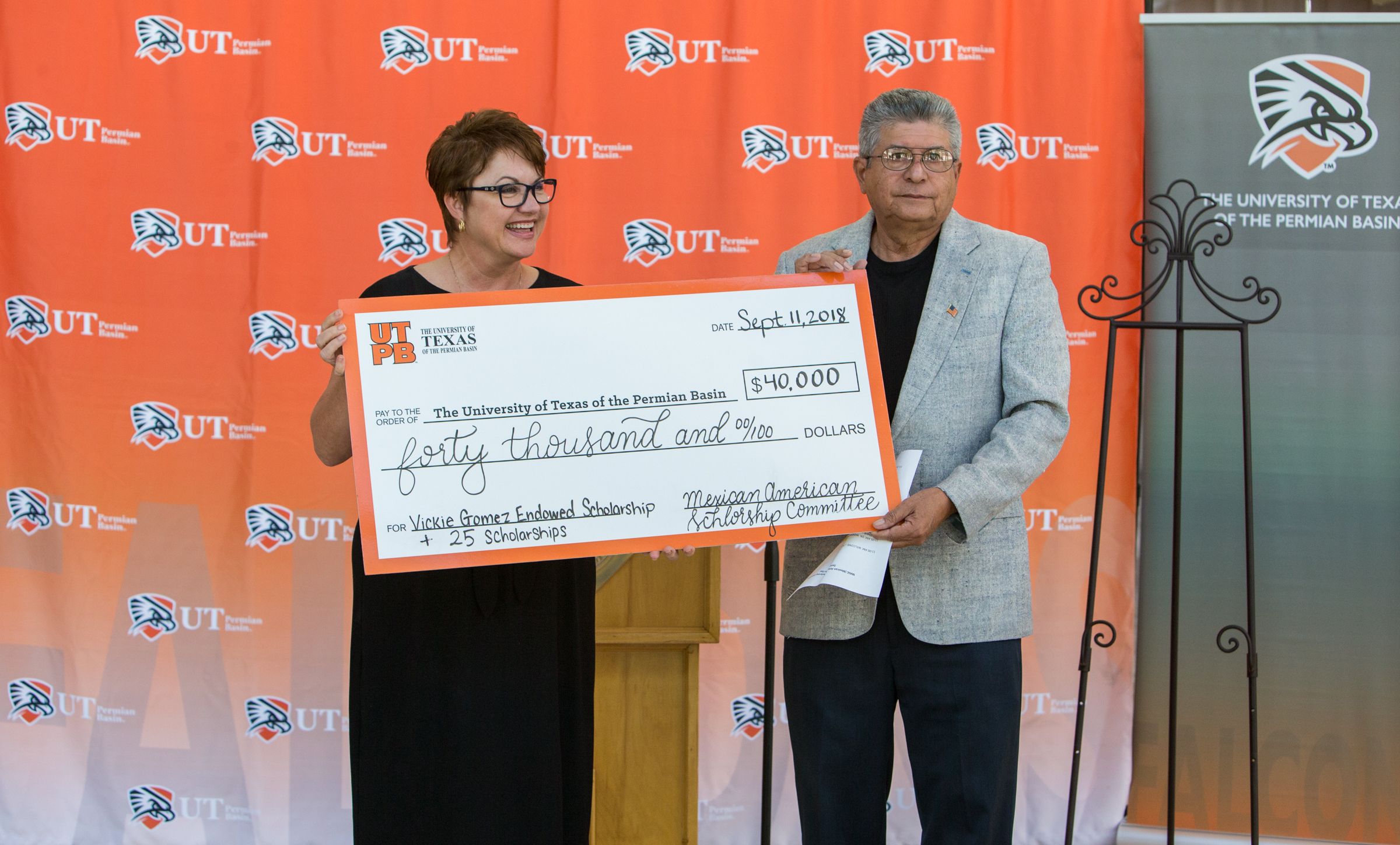 Dr. Woodley accepts donation for student scholarships
