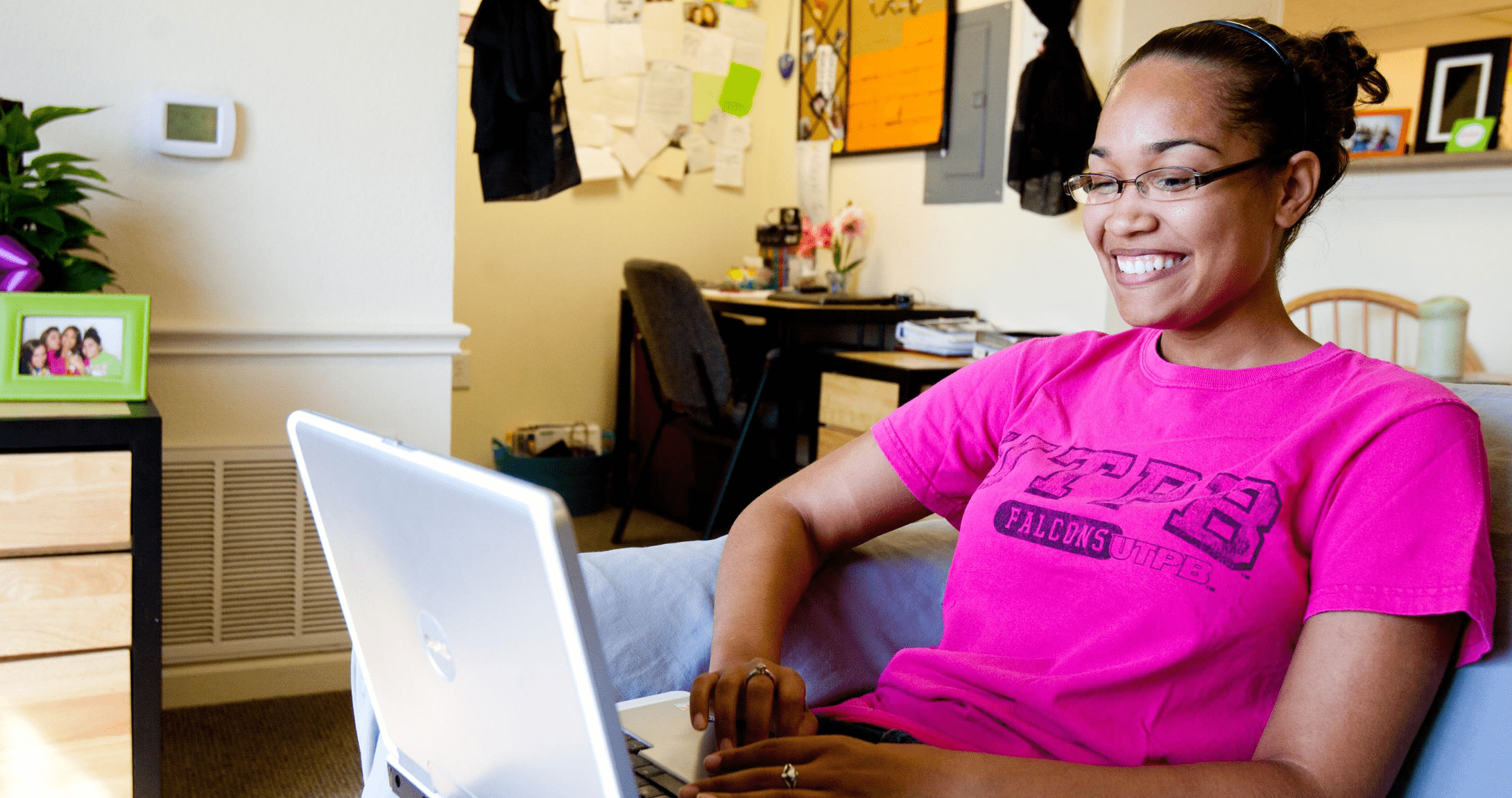 Student studying on computer in dorm room