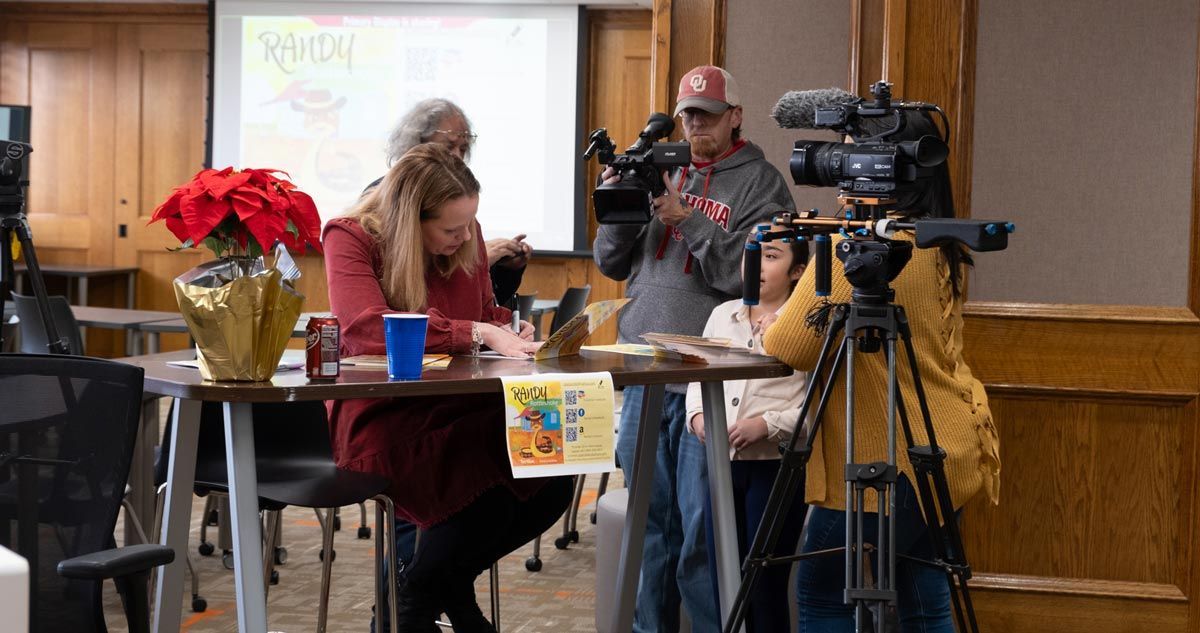 College of Education faculty signing book