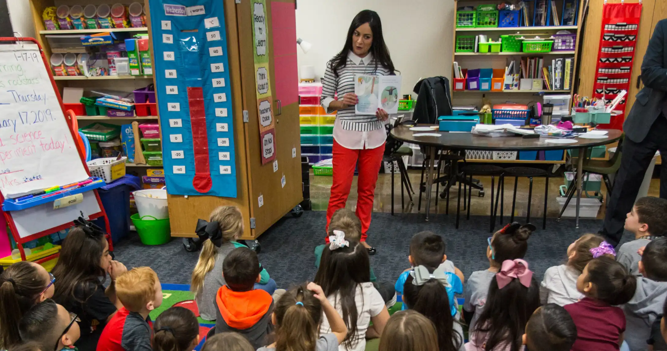 Teacher reading to kids in classroom