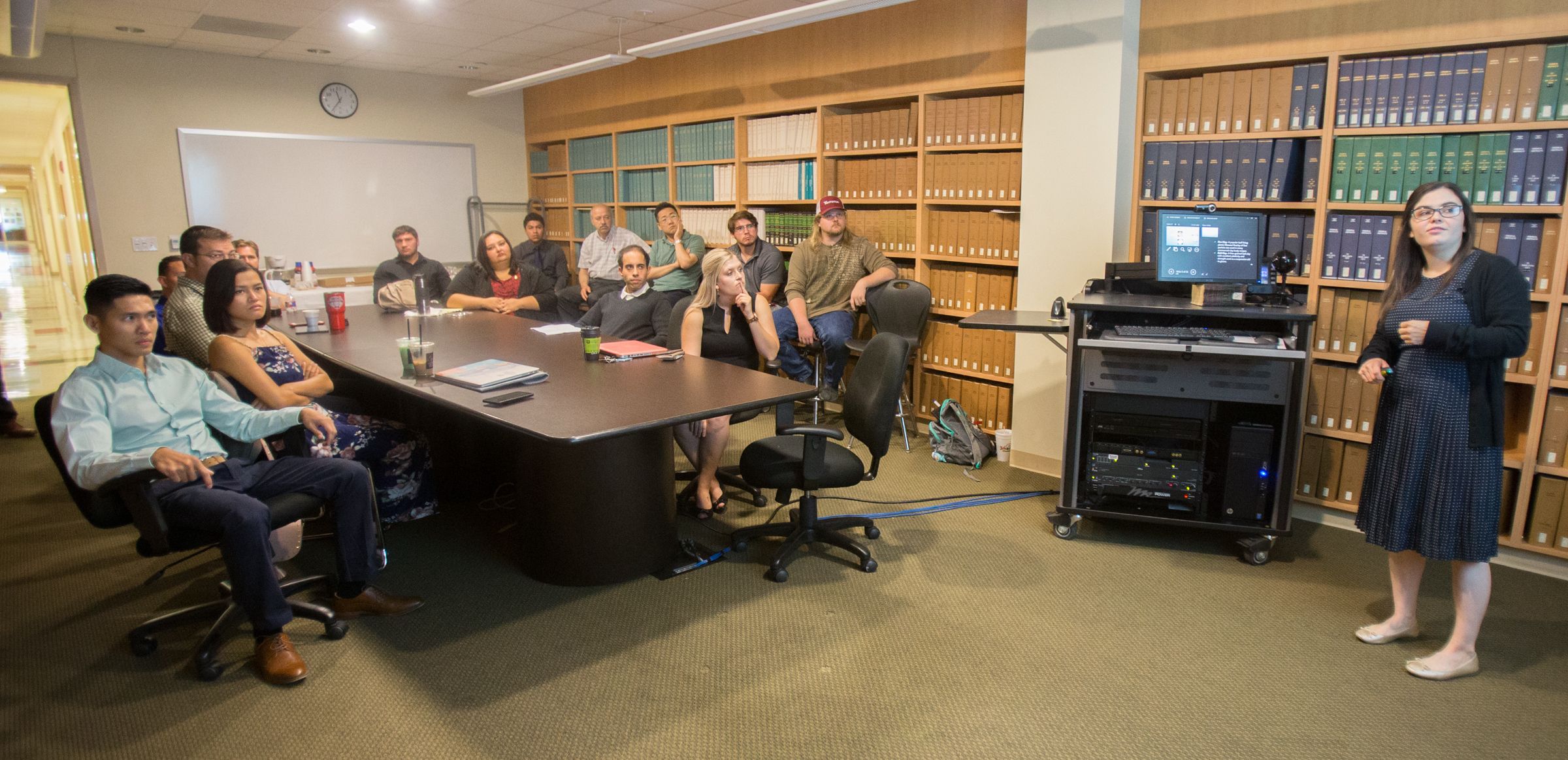 STEM students sitting around table during presentation
