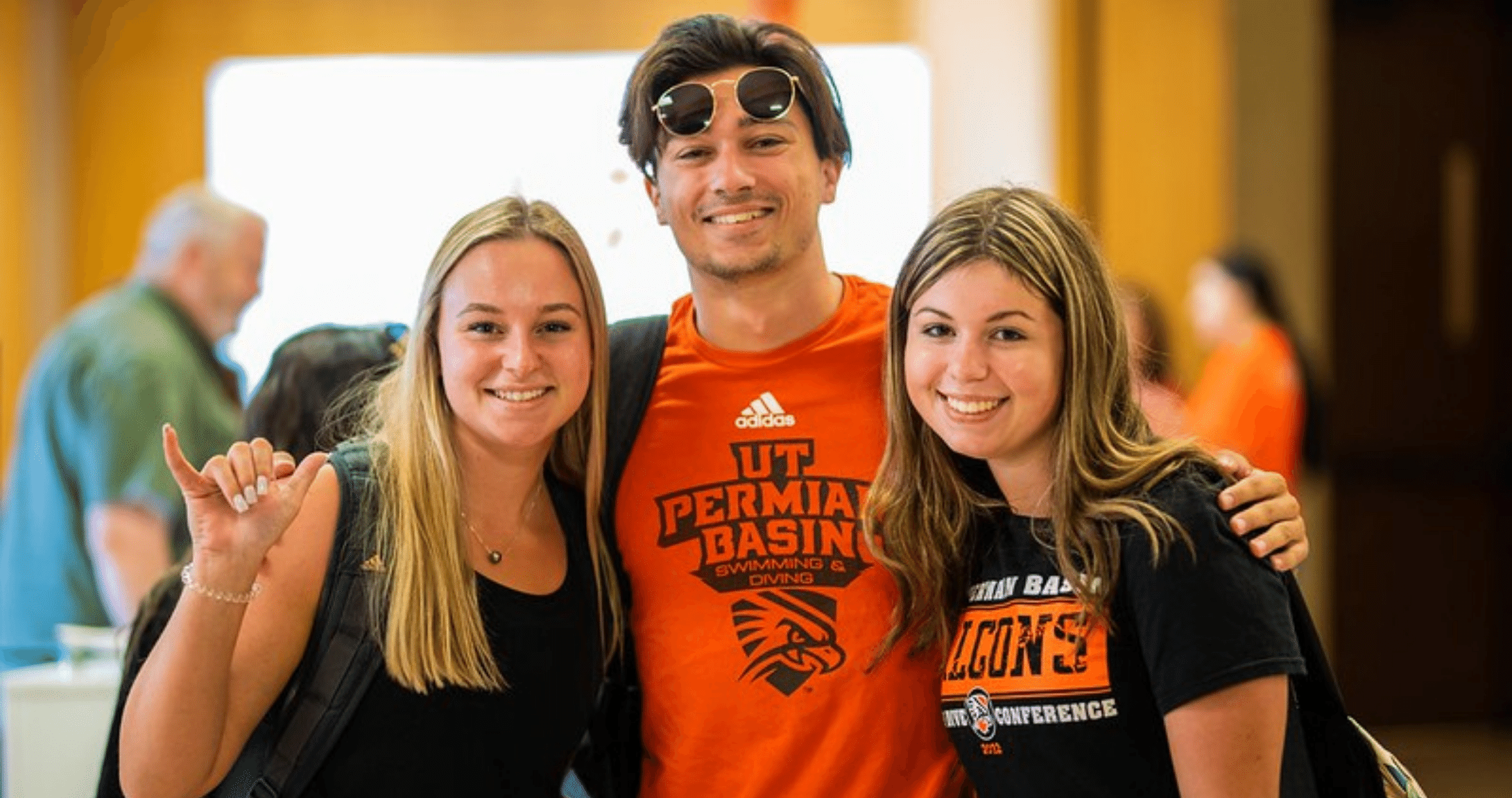 students on campus smiling at camera