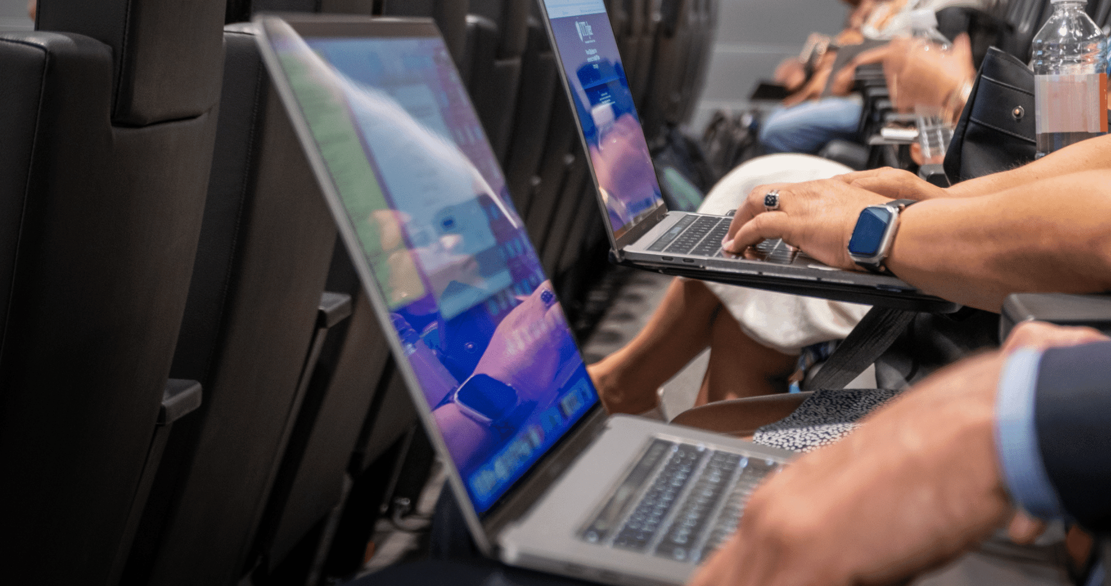 people typing on laptop