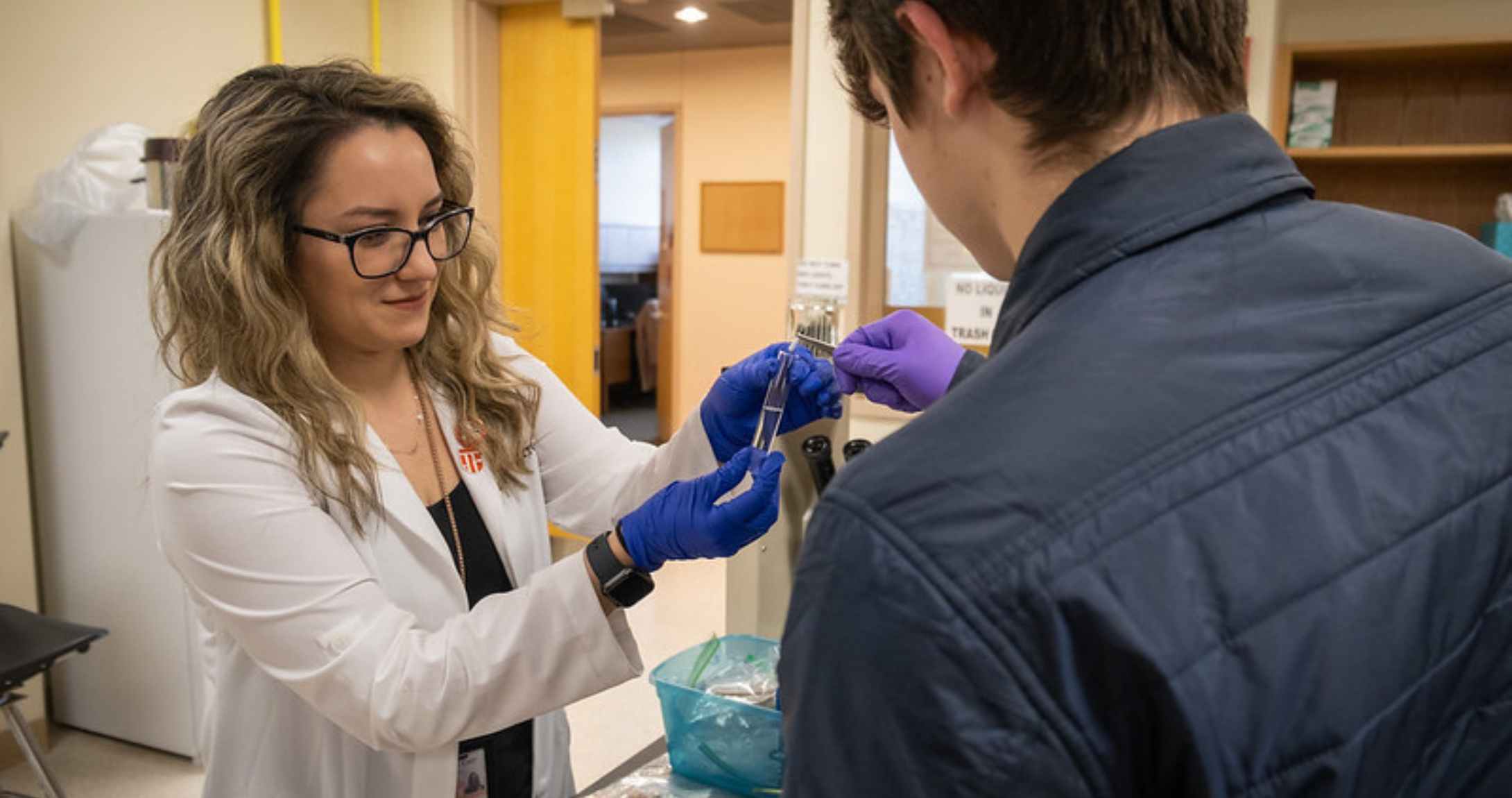 professor teaching student in biology lab