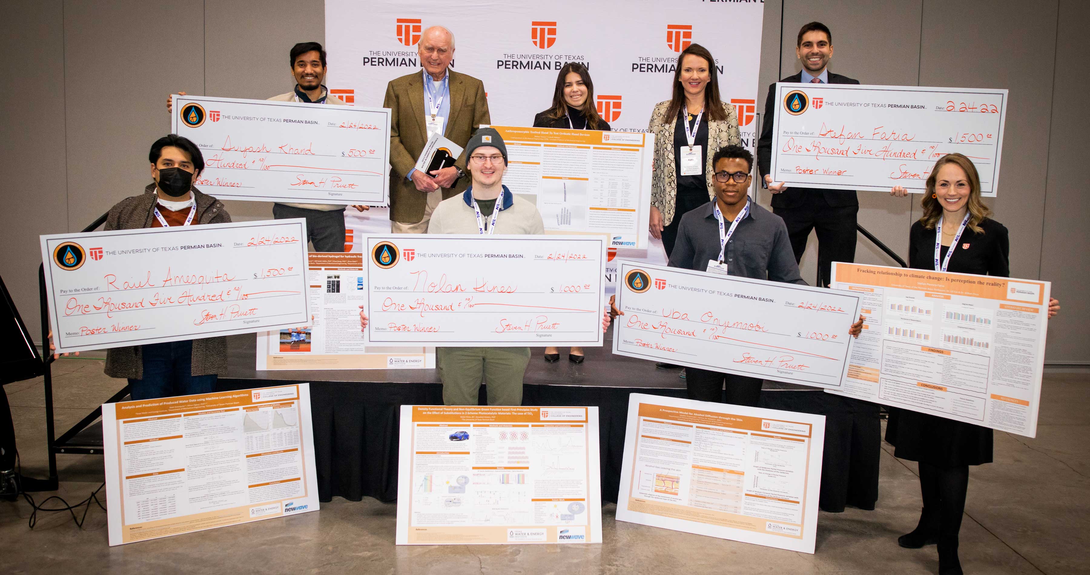 Scholarship winners and their large presentation checks