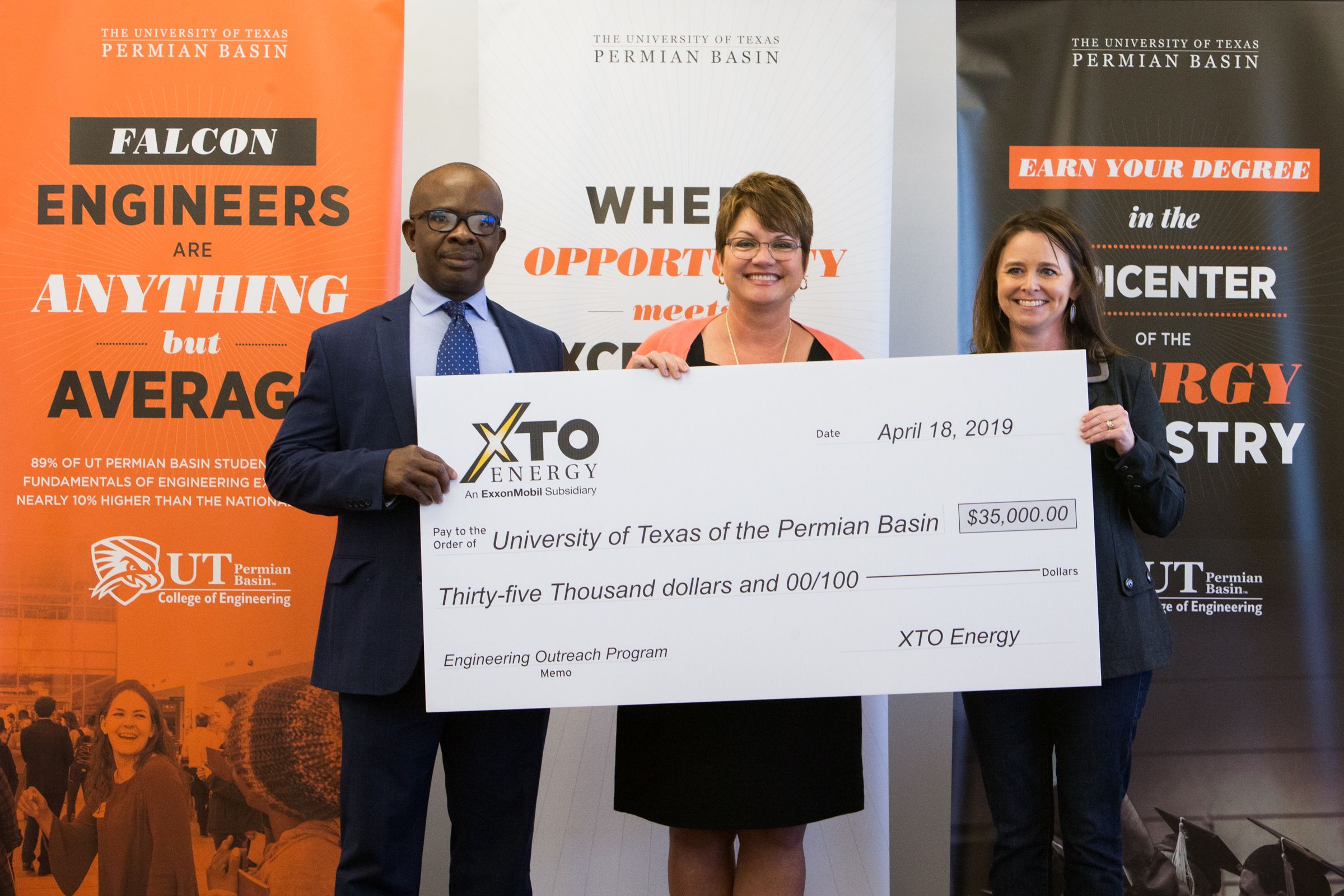 XTO Energy presents check to Dr. Woodley and Dr. Nnanna