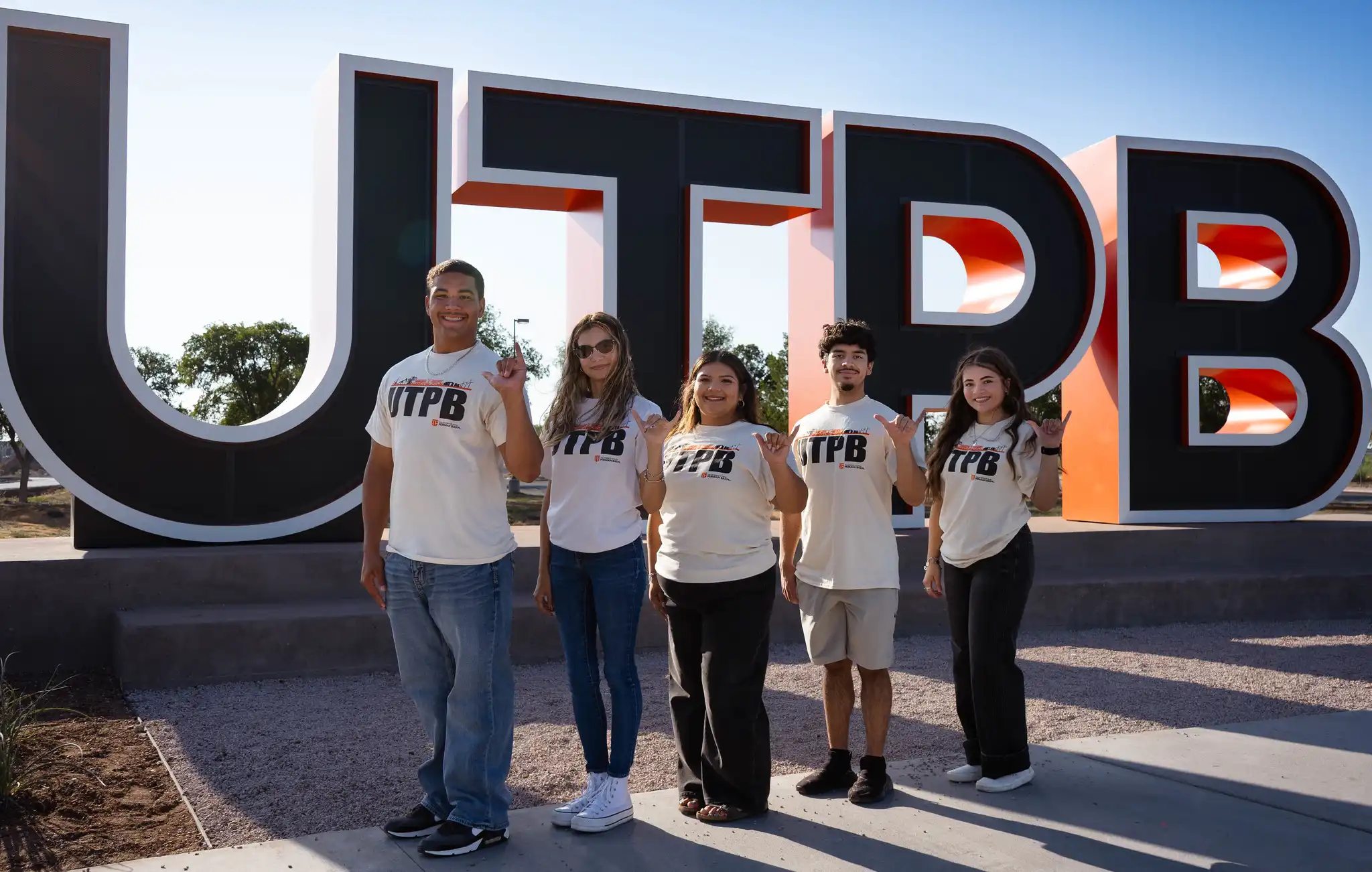 Student Leaders standing in front of the large UTPB letters on campus